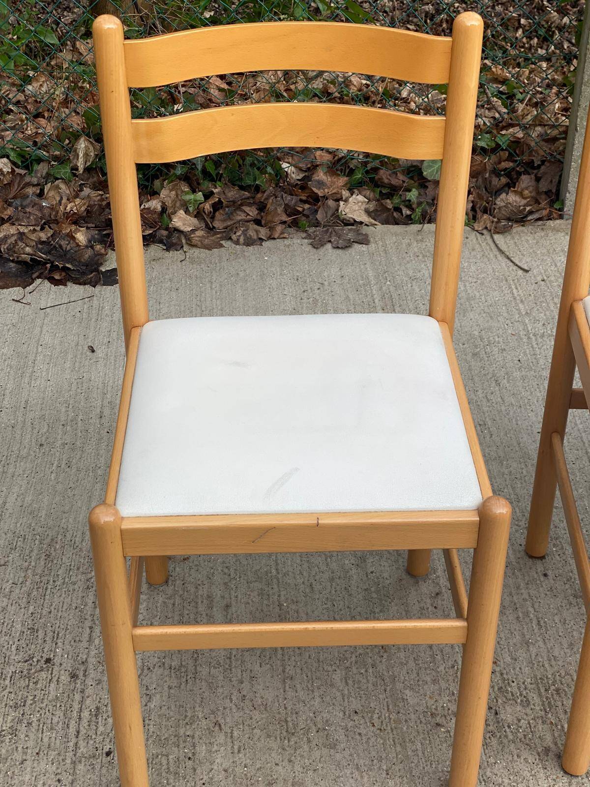 4 solid wood and white leather chairs