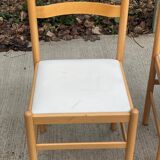 4 solid wood and white leather chairs