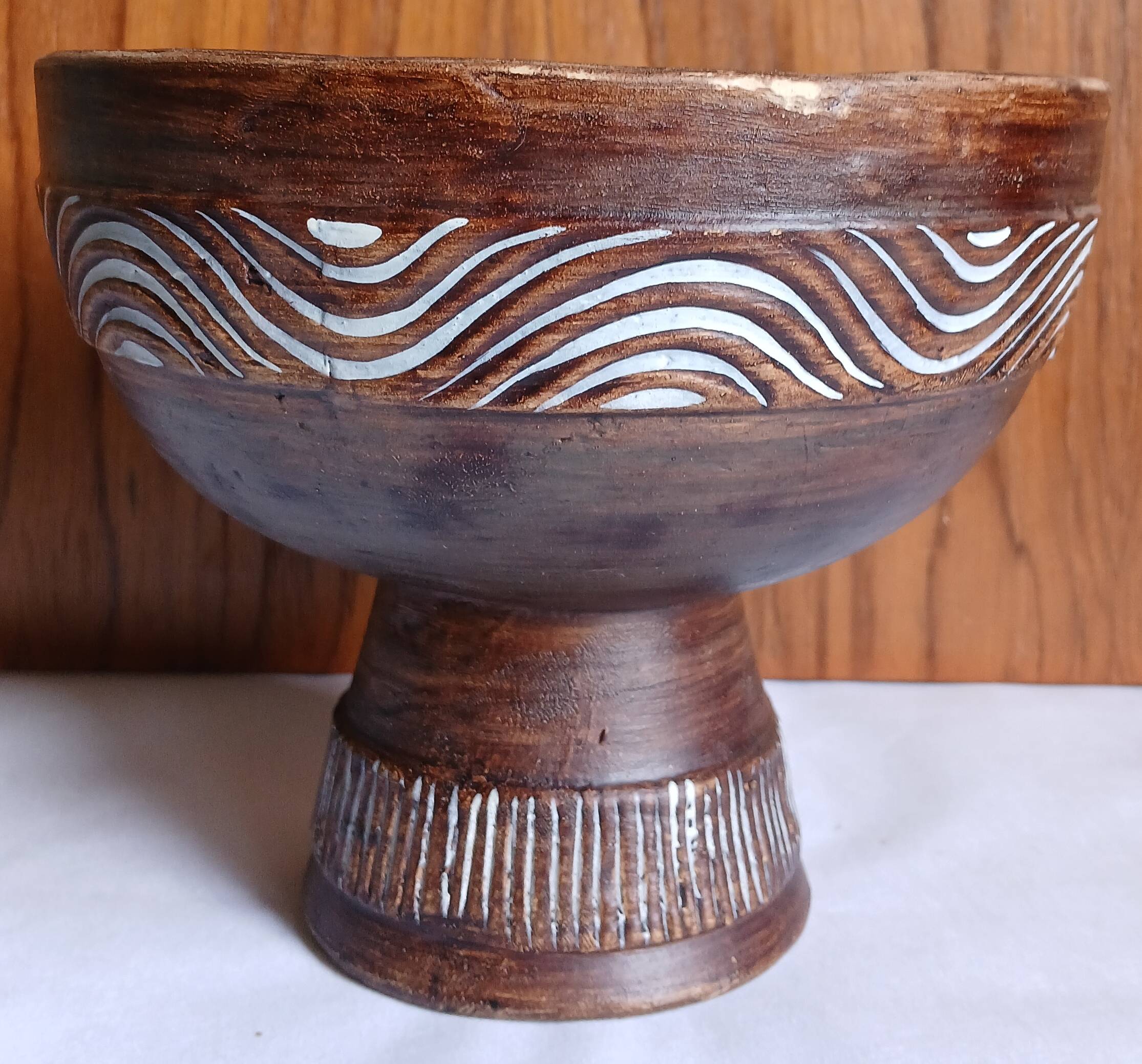 Cup on a pedestal in handcrafted scarified ceramic.