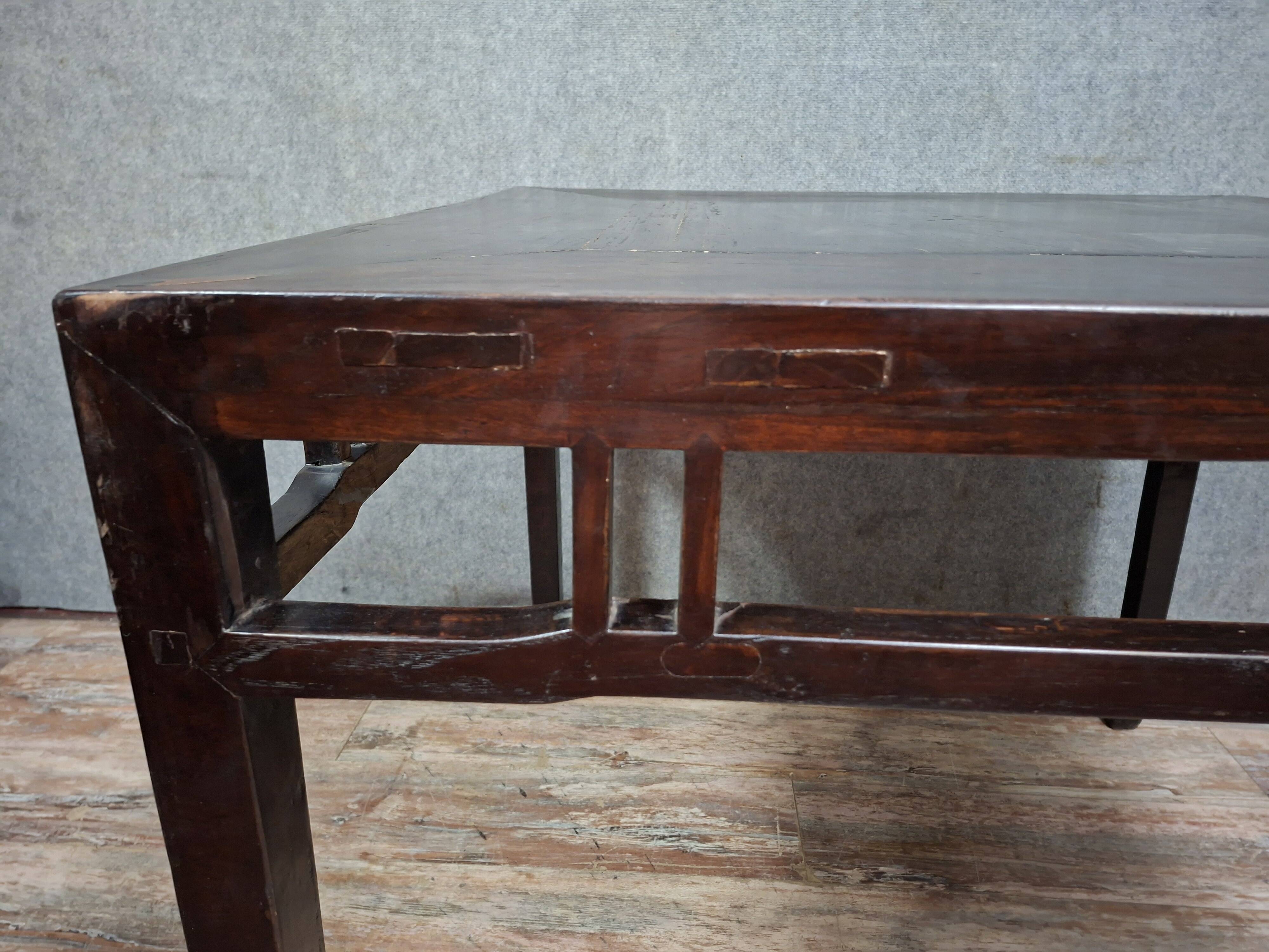 ancient Asian table, made of solid wood with a dark brown patina