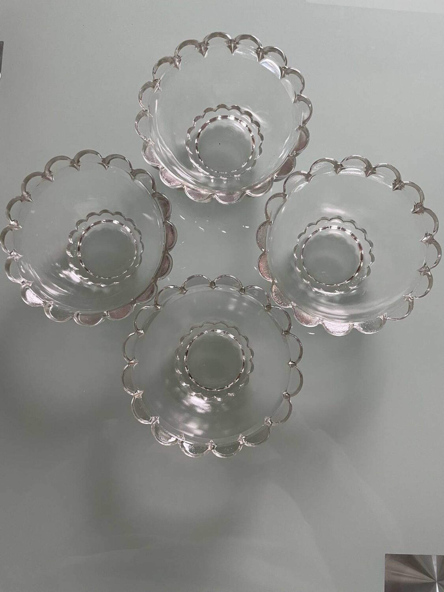 Four vintage clear glass bowls.