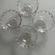Four vintage clear glass bowls.