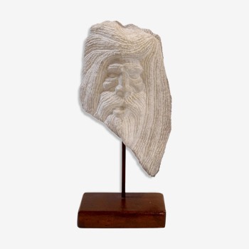 Carved stone head sculpture