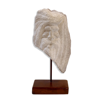 Carved stone head sculpture
