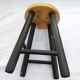 Low wooden stool and black patina