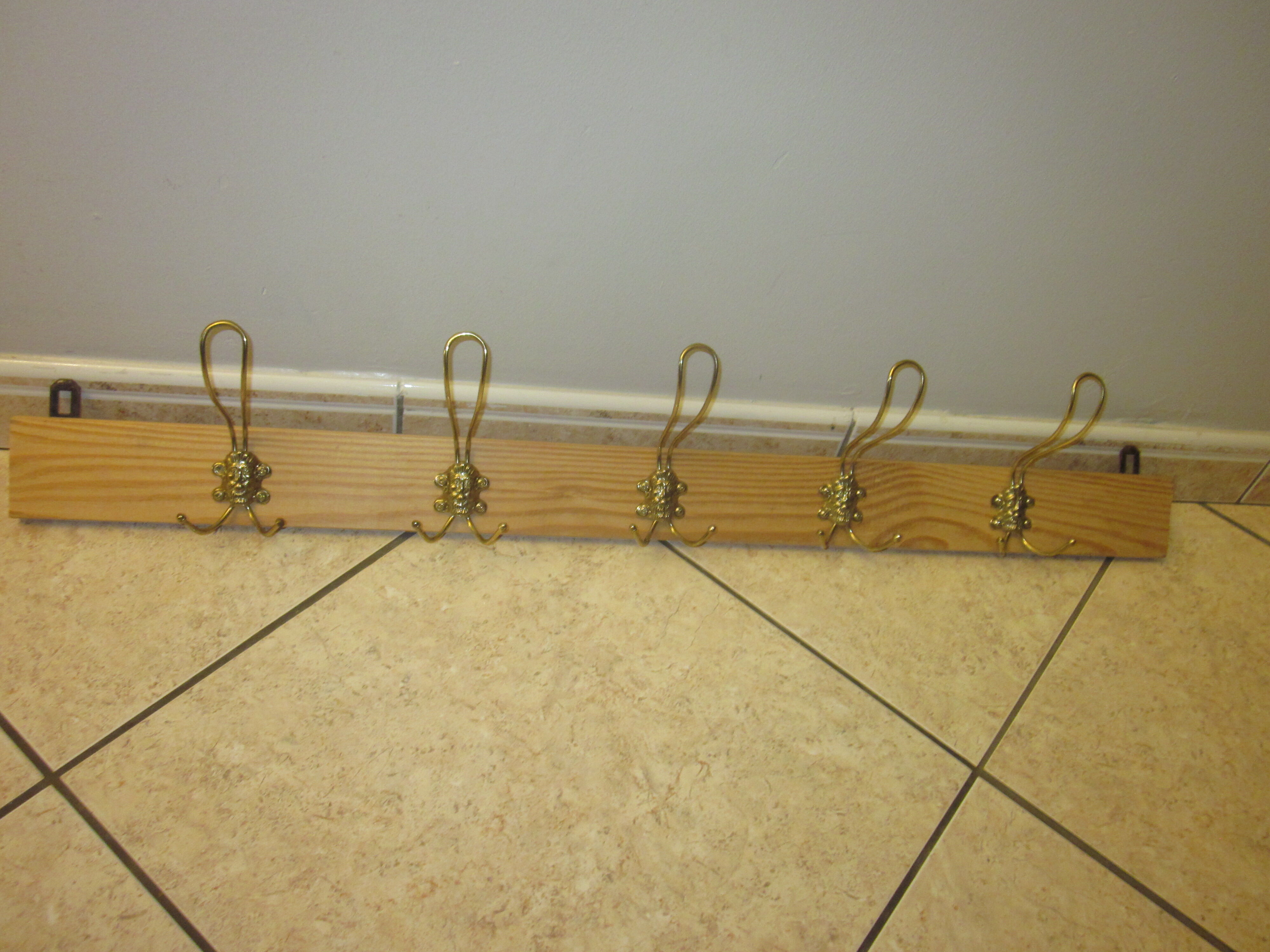 old coat rack with 5 metal hooks