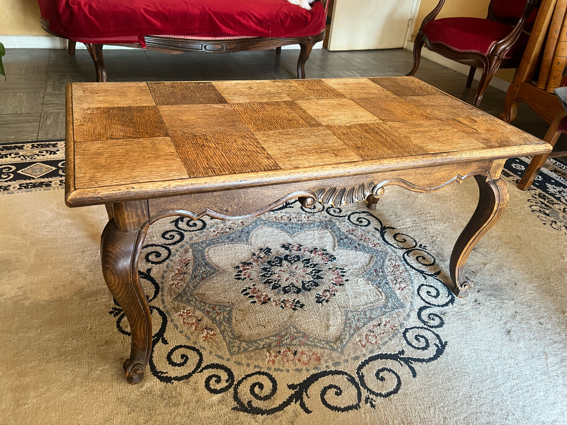Antique coffee table with carved wood mouldings.