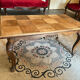 Antique coffee table with carved wood mouldings.
