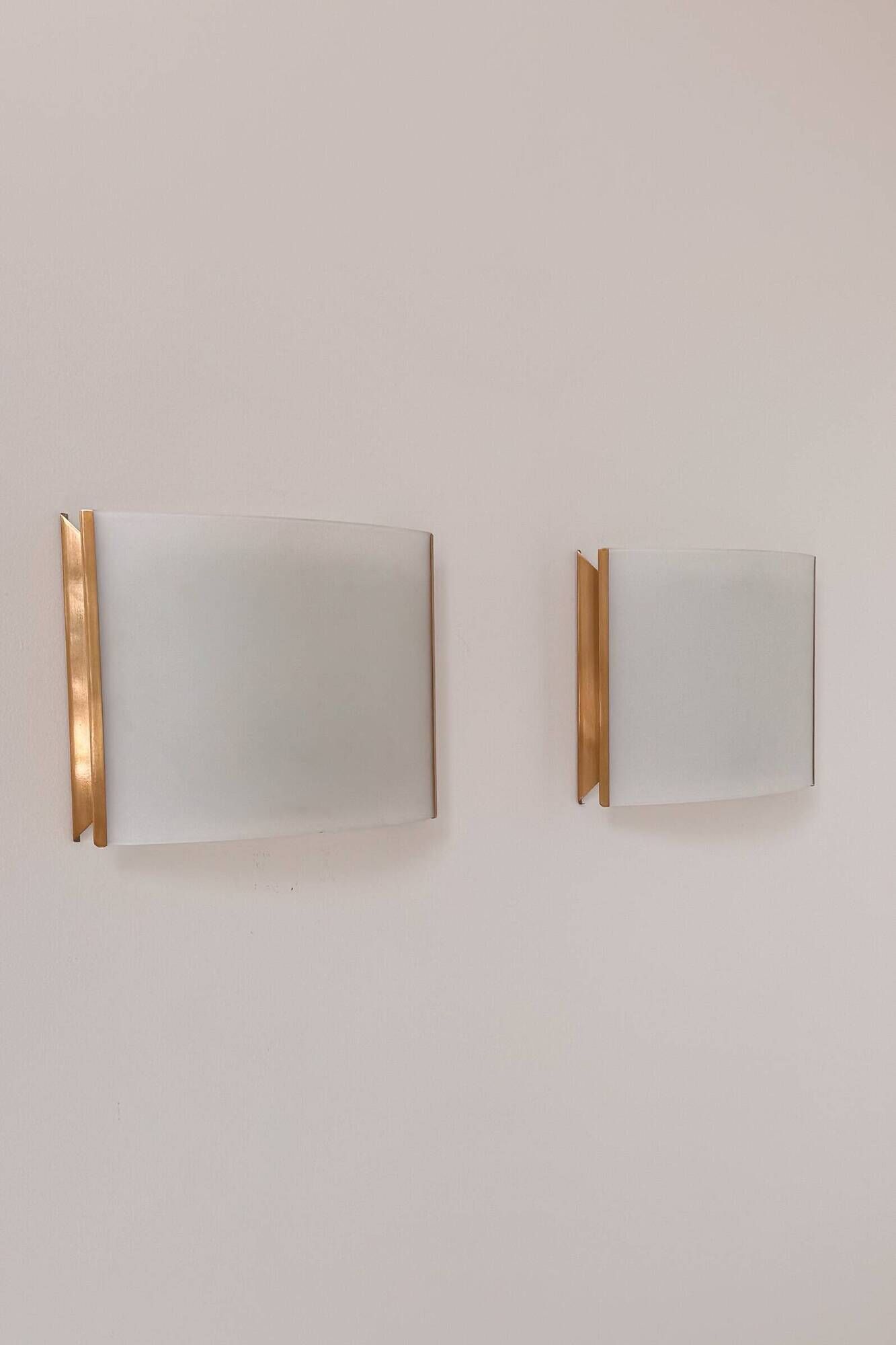 Pair of vintage brass and curved glass wall lights, France, 1970.