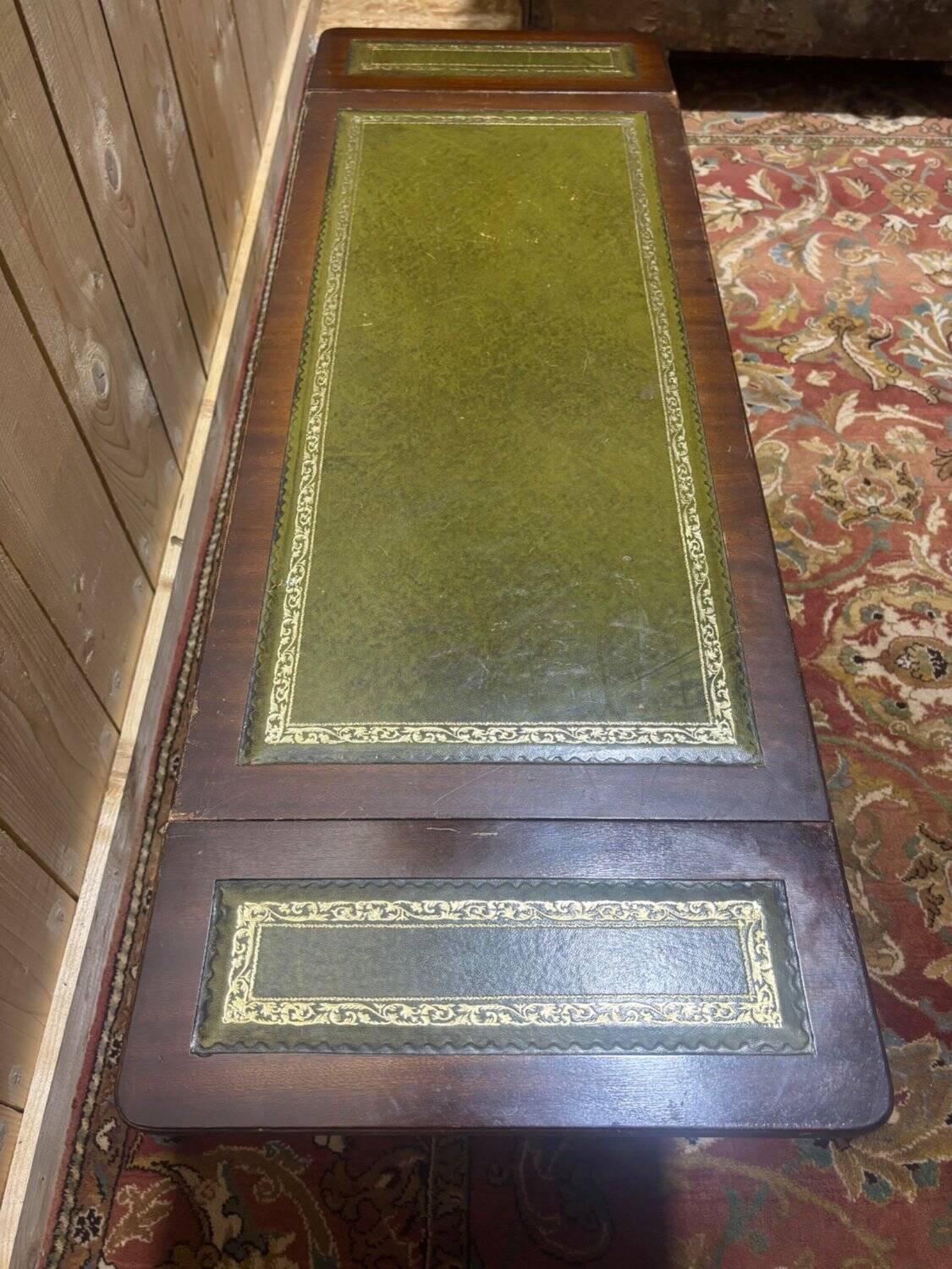 English Regency coffee table, mahogany & green stamped leather with gold.