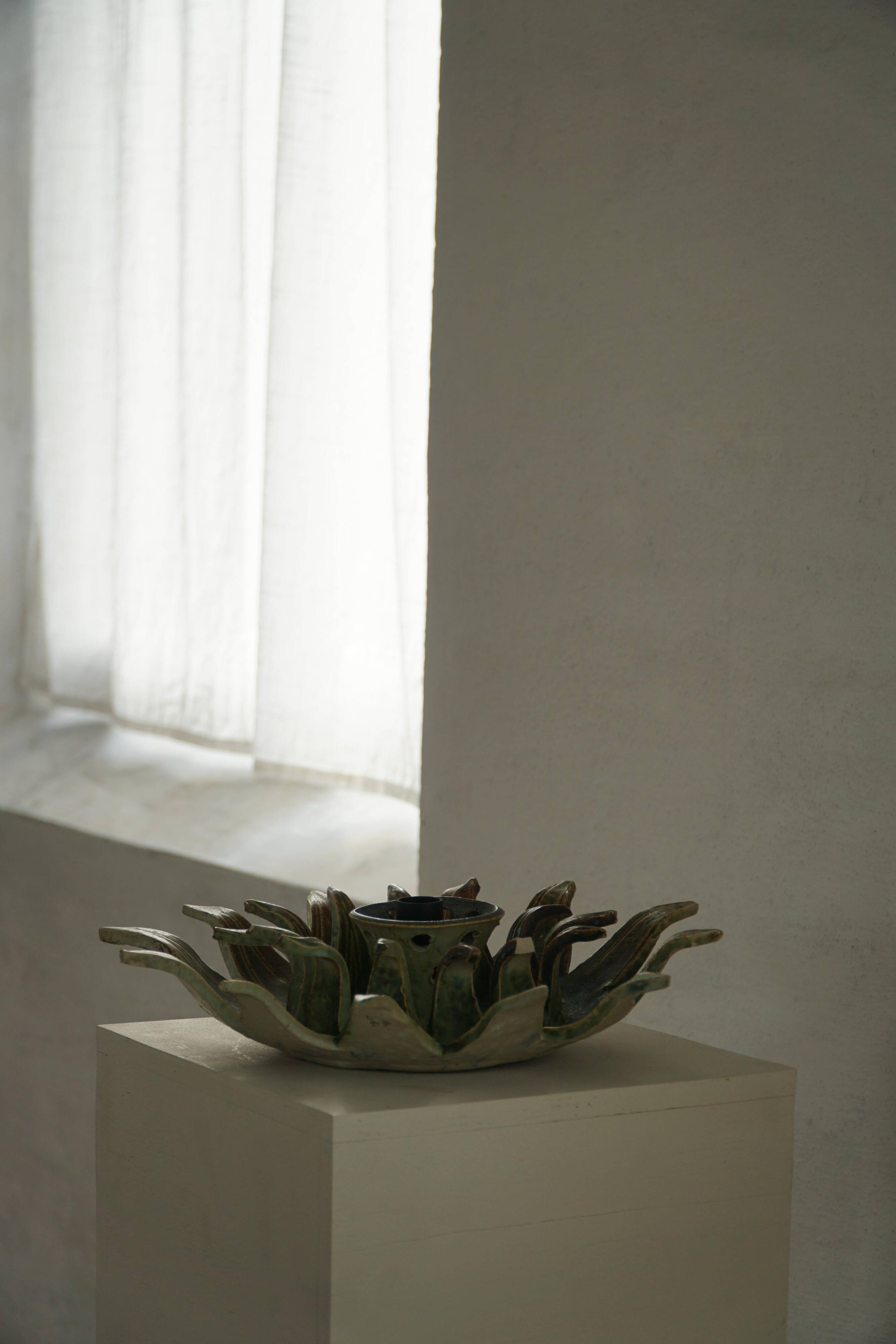 Wall lamp or decorative wall sculpture in ceramic in the shape of a sun, mid-20th century, 1960.