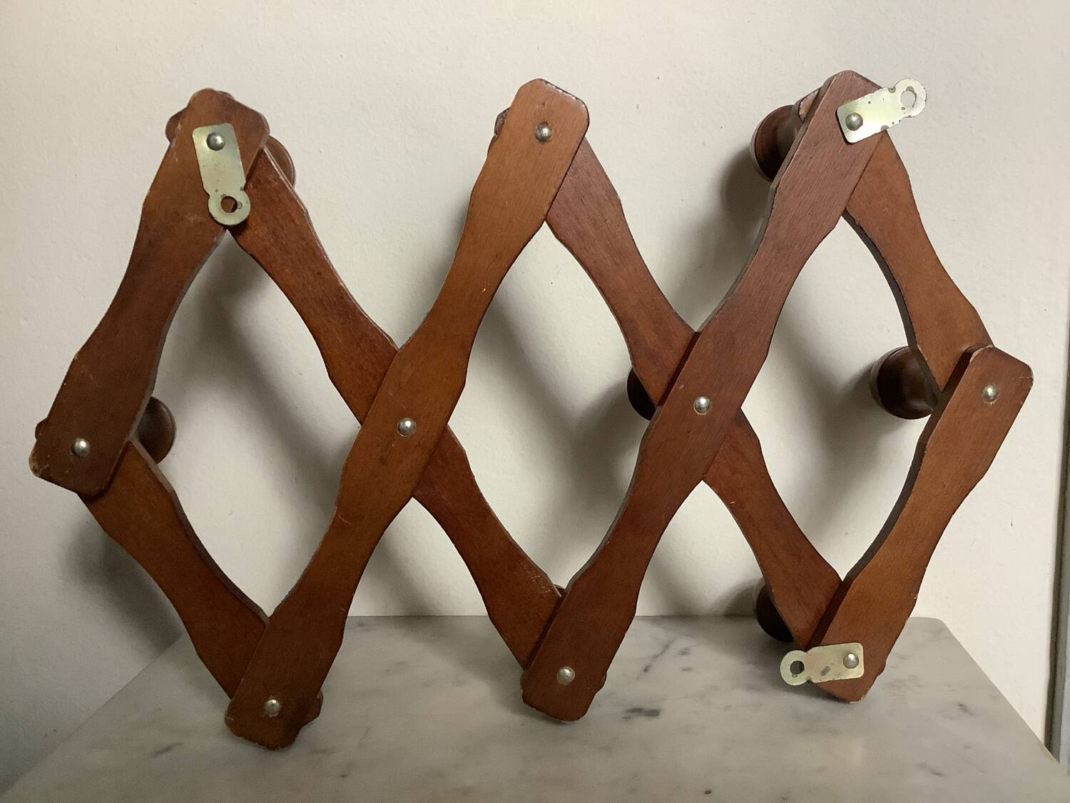 Old wooden accordion coat rack.