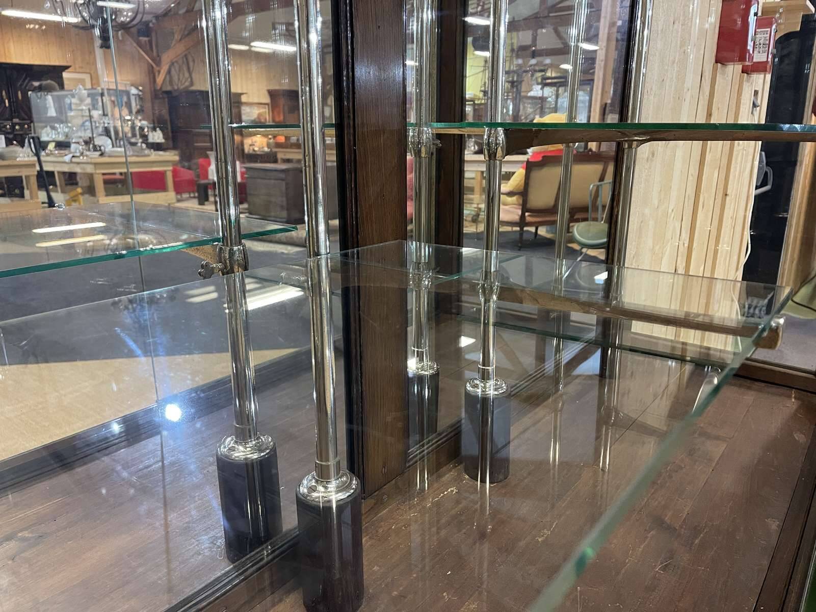 Early 20th-century shop display cabinet in oak with sliding doors.