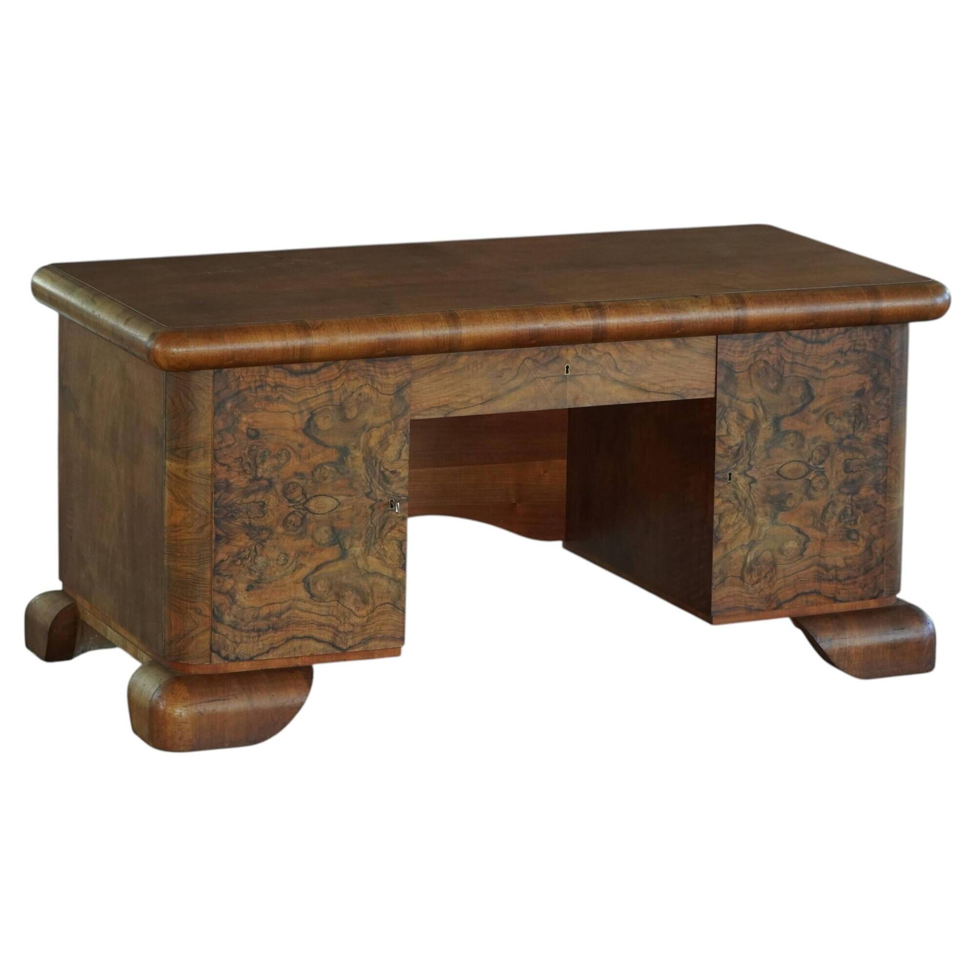 Art Deco desk, sculptural and expressive, in walnut, made by a French cabinetmaker, 1930s.