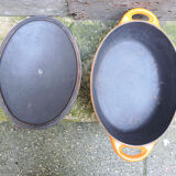 Old oval casserole in orange enamelled cast iron