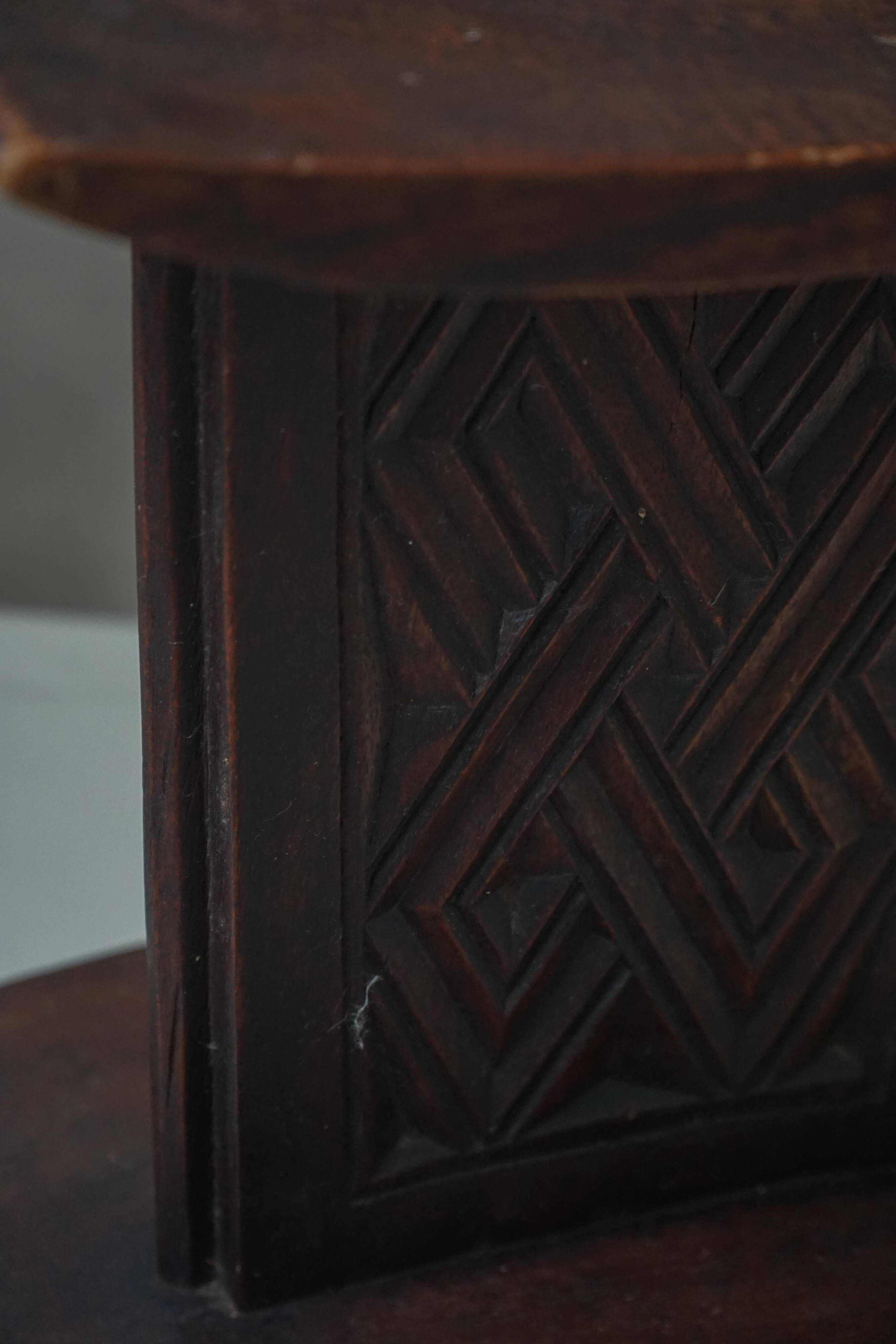 Sculptural African stool in hardwood, curved seat and architectural base, 1970s.