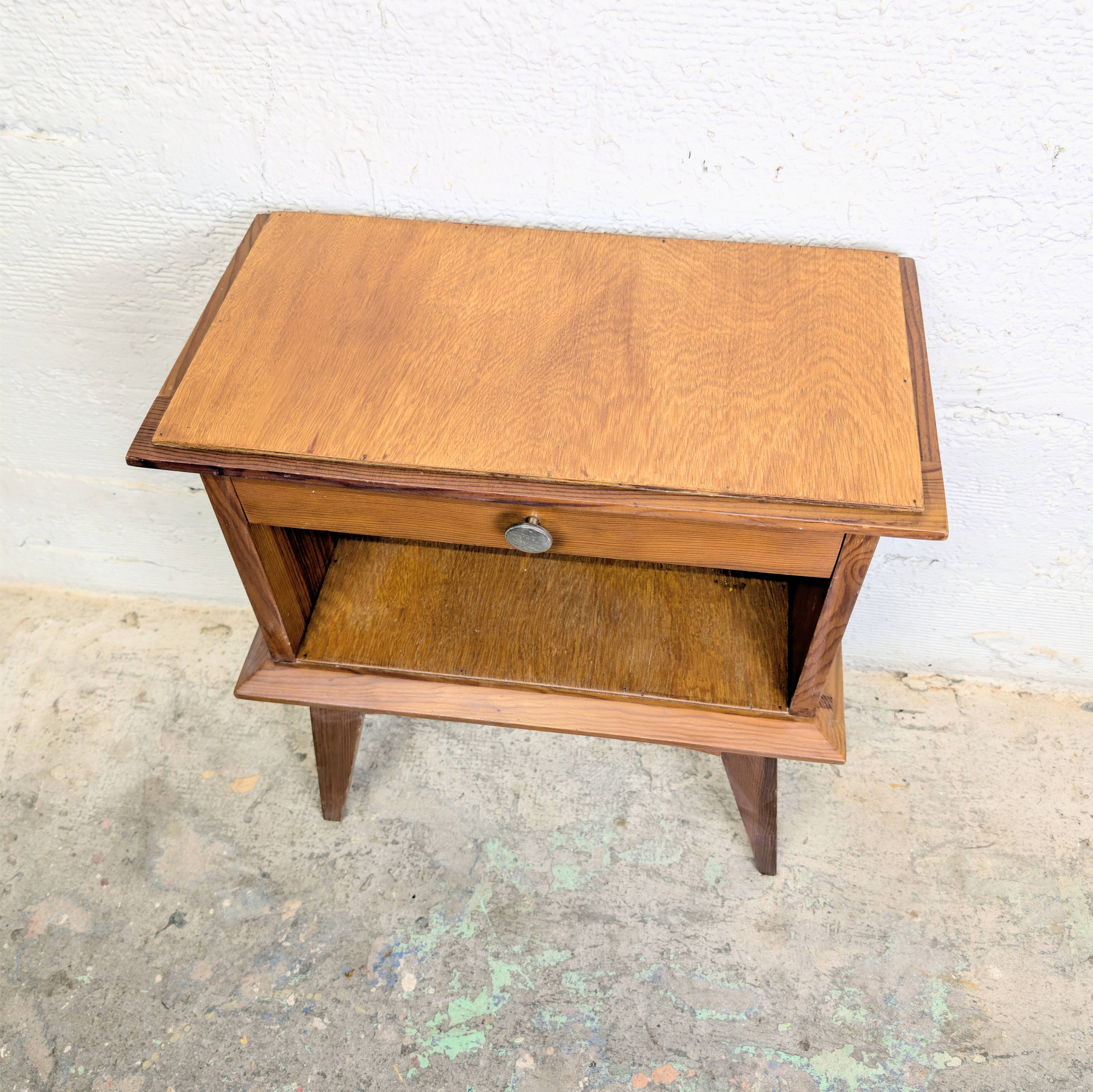 Vintage bedside table with tapered legs.