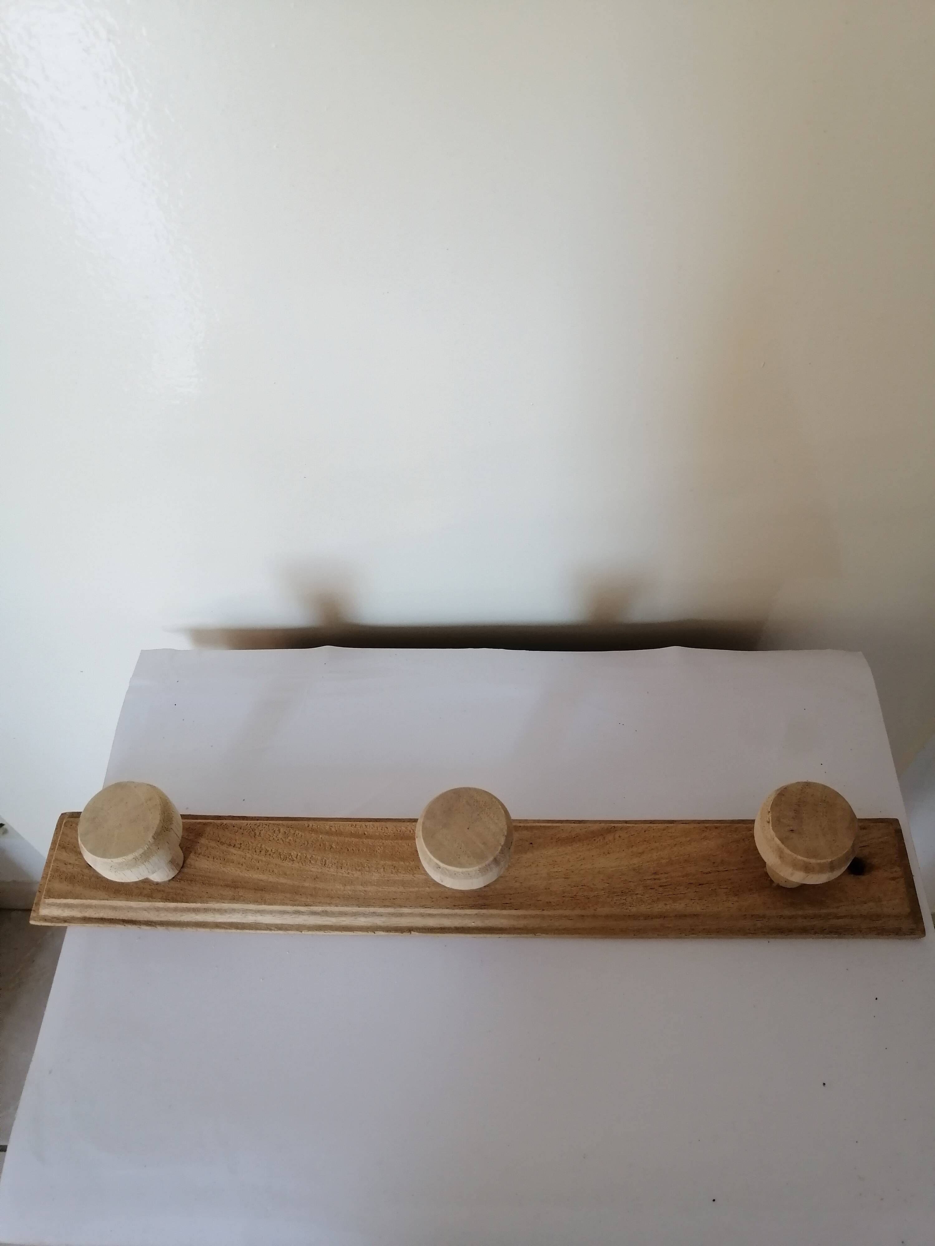 Old wall coat rack in raw wood