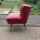 Mid-century cocktail chair in red vinyl and beech, ribbed backrest, 1950s.