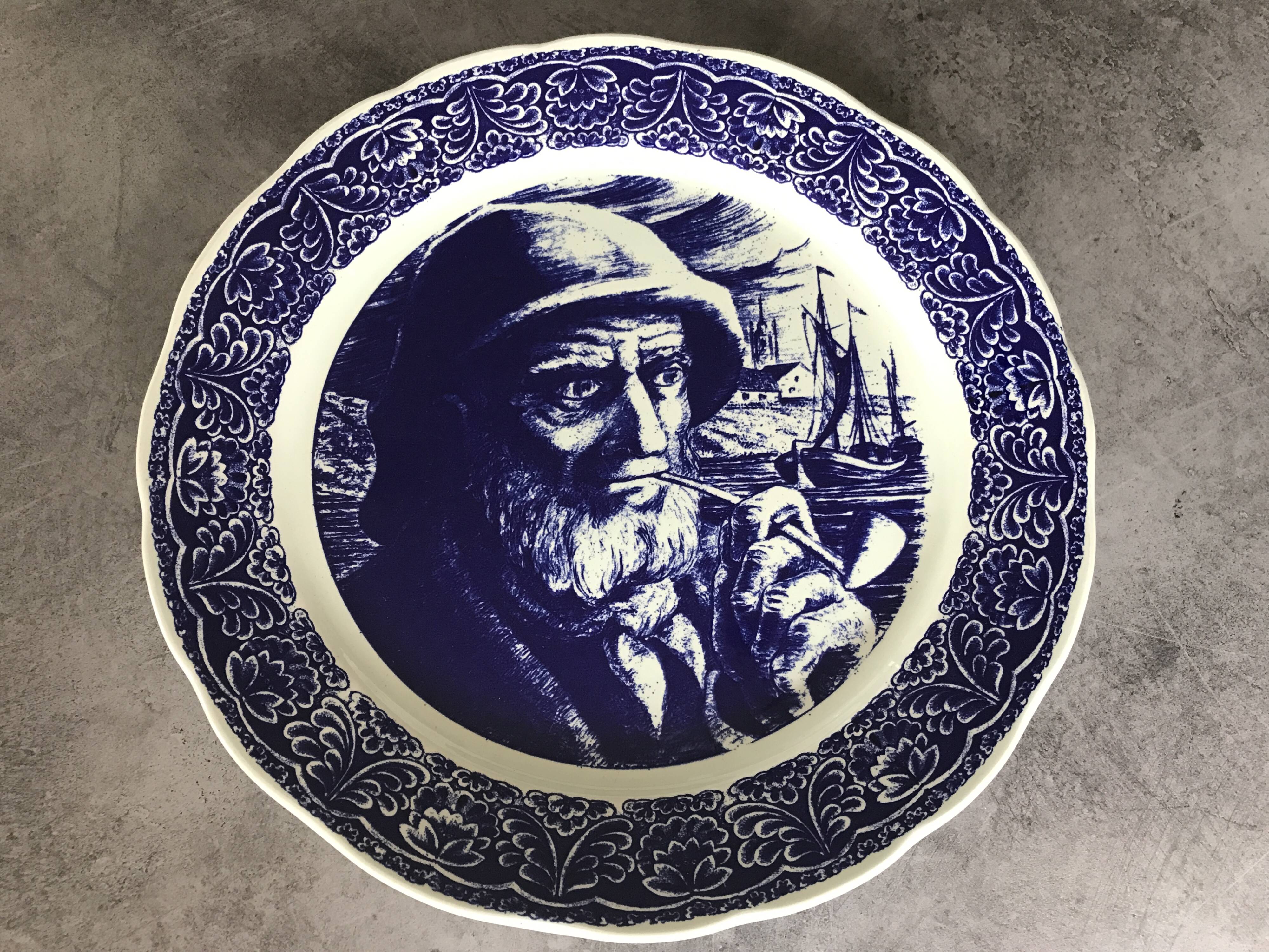 Blue enamelled earthenware wall plate with fisherman decor, Boch La Louvière, Belgium