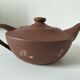 Japanese teapot in red clay engraved with integrated filter.