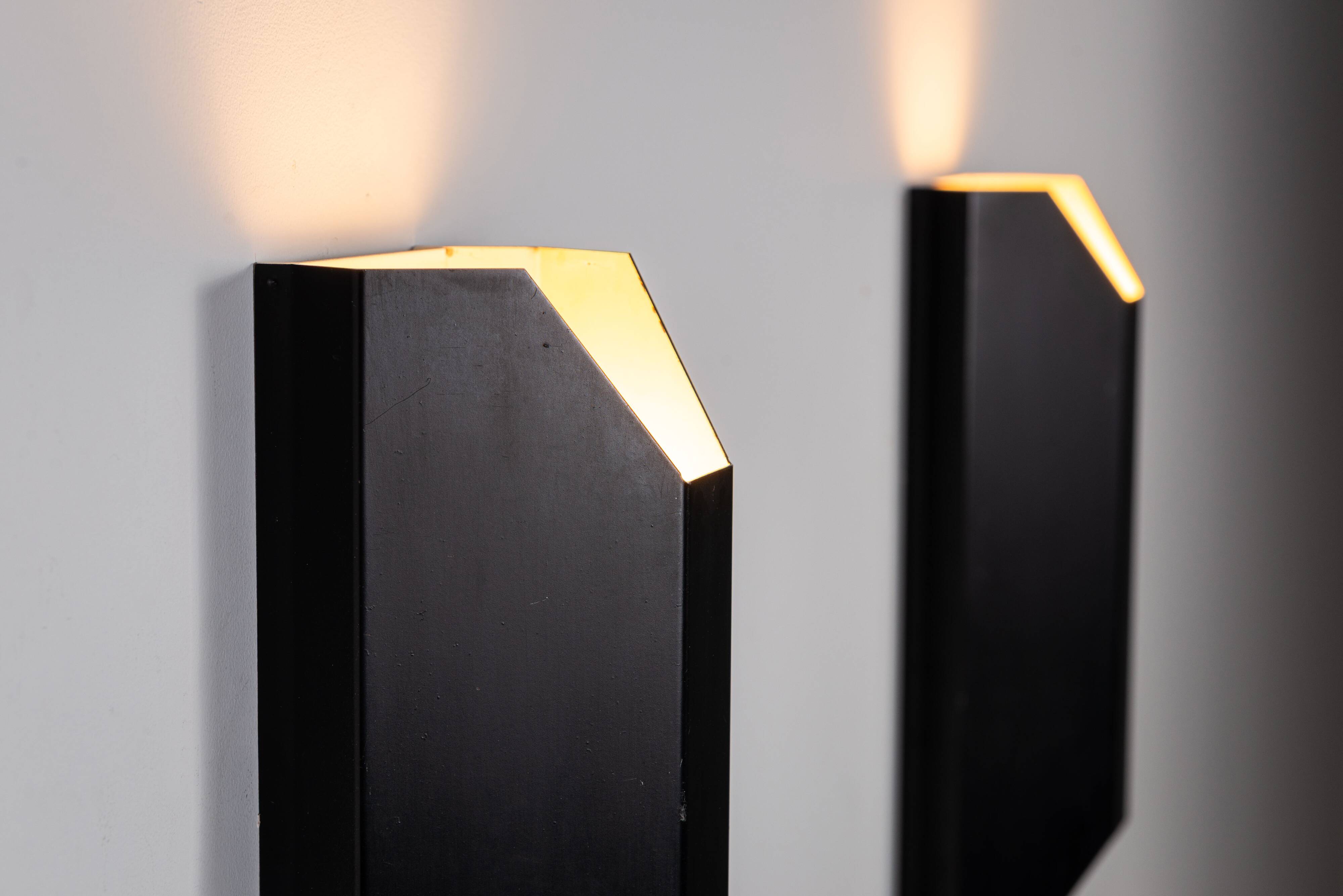 Architectural pair of vintage black metal wall lamps with angular geometric