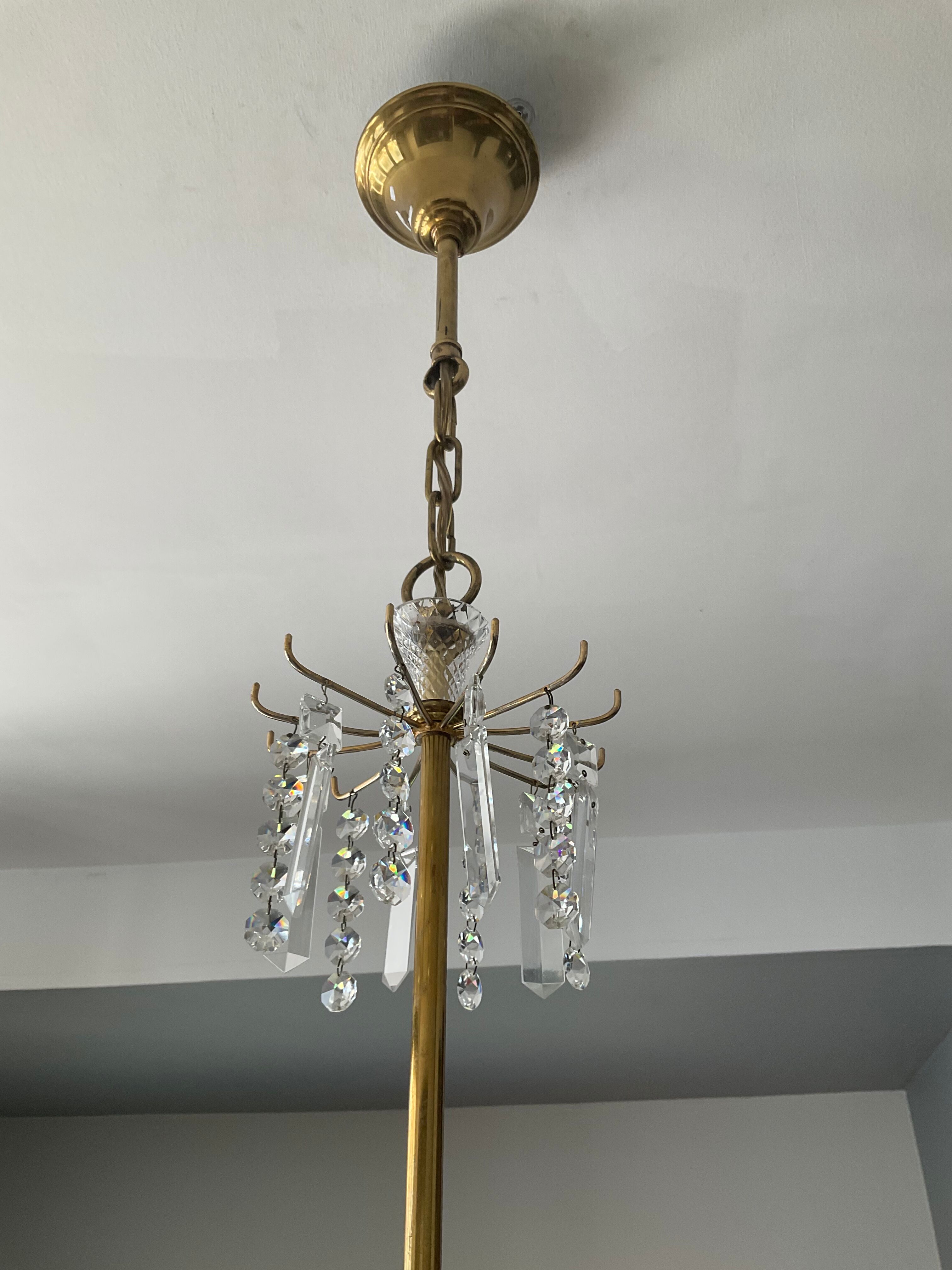 Old brass chandelier and crystal grapevines