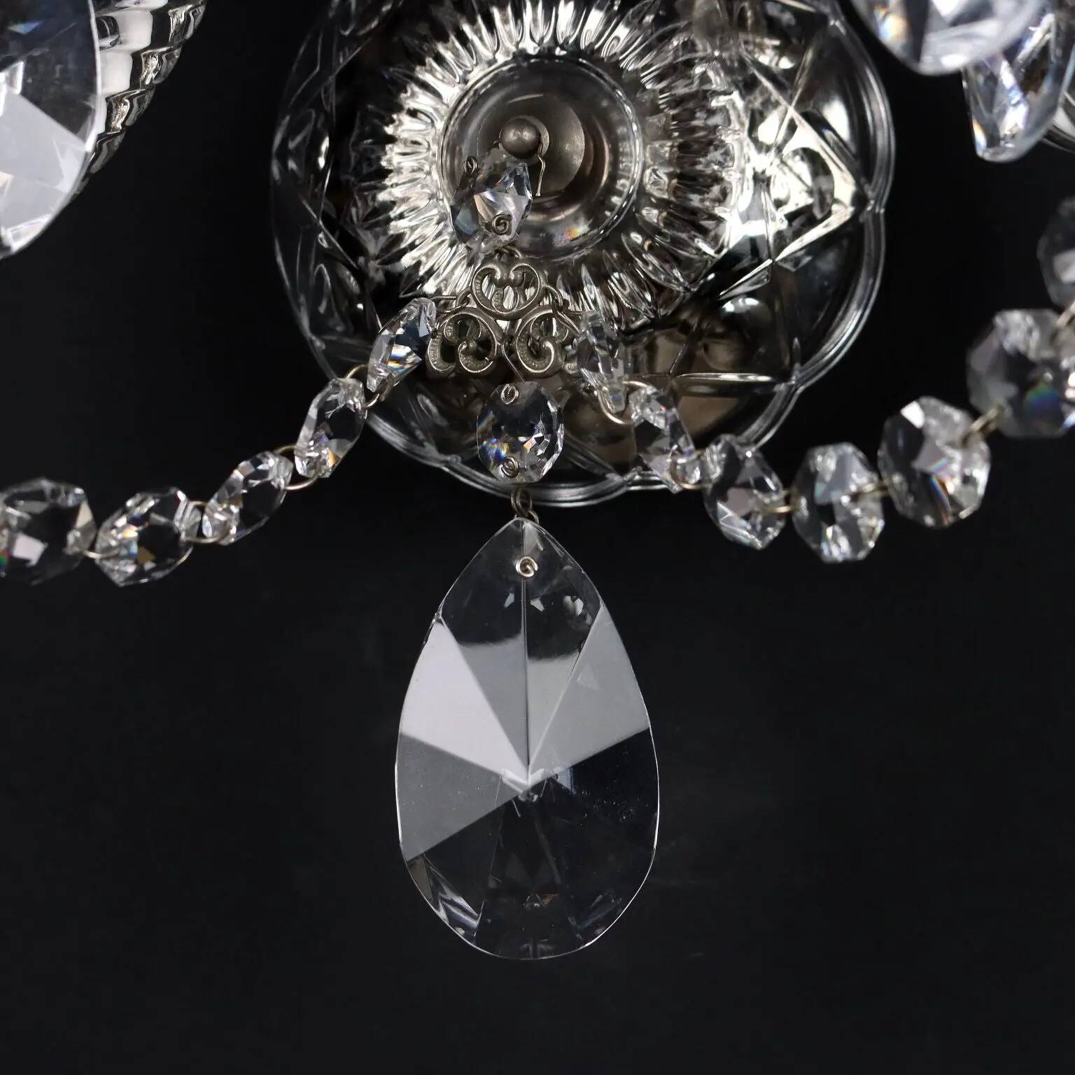 Antique wall light with 2 lights from the 1900s, featuring crystal bobeches and pendants.