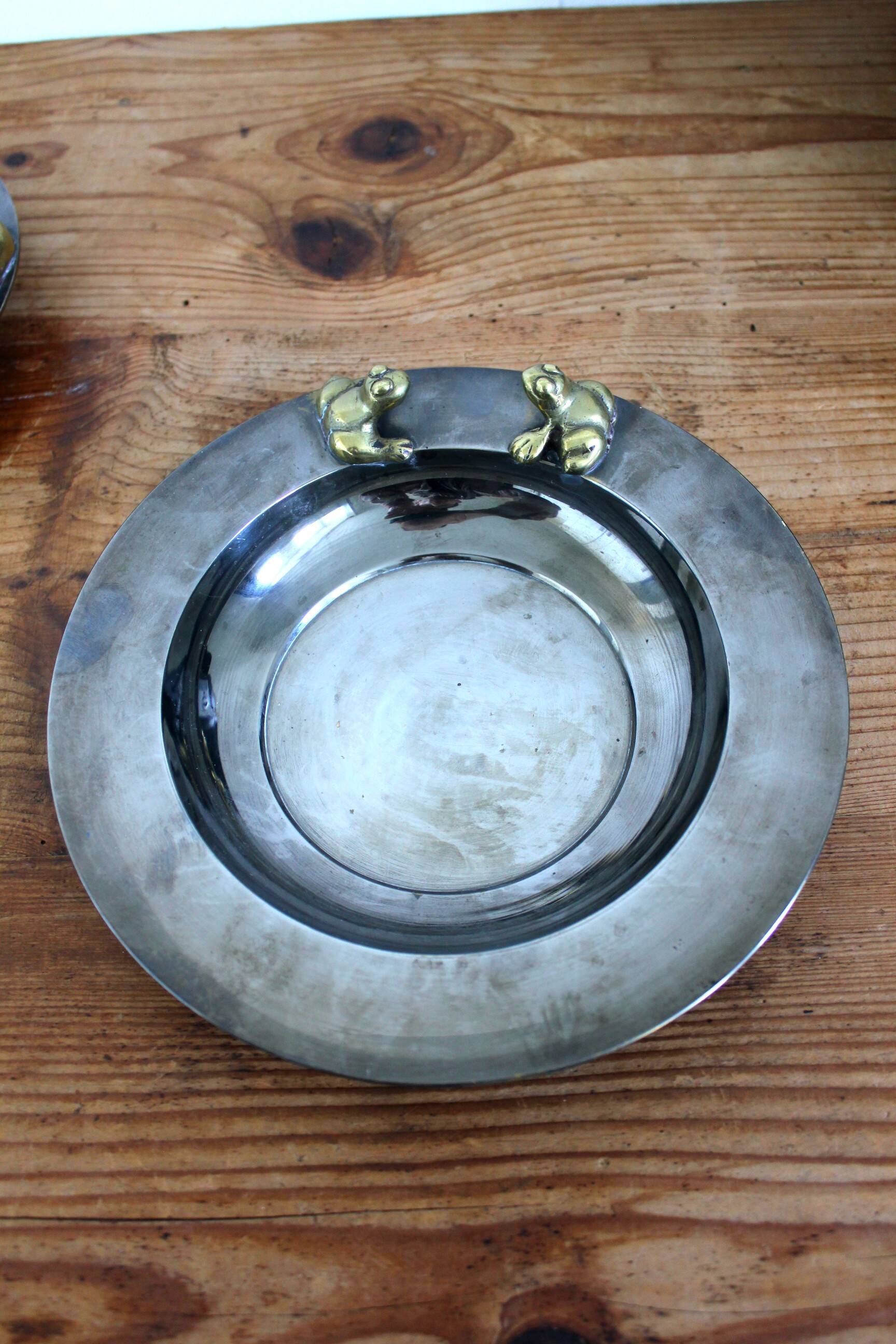2 antique round serving trays with bronze handles and chrome finish.