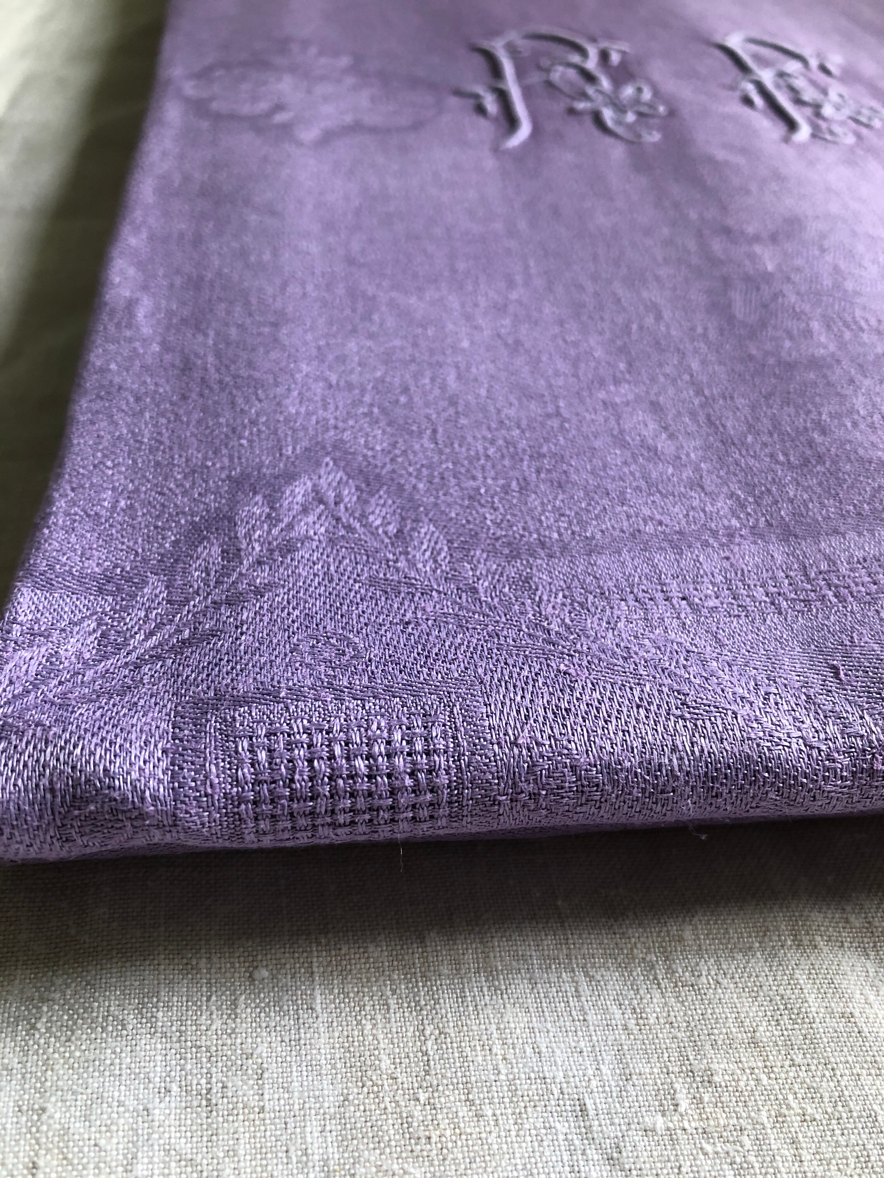 Old damask tablecloth in linen and purple silk