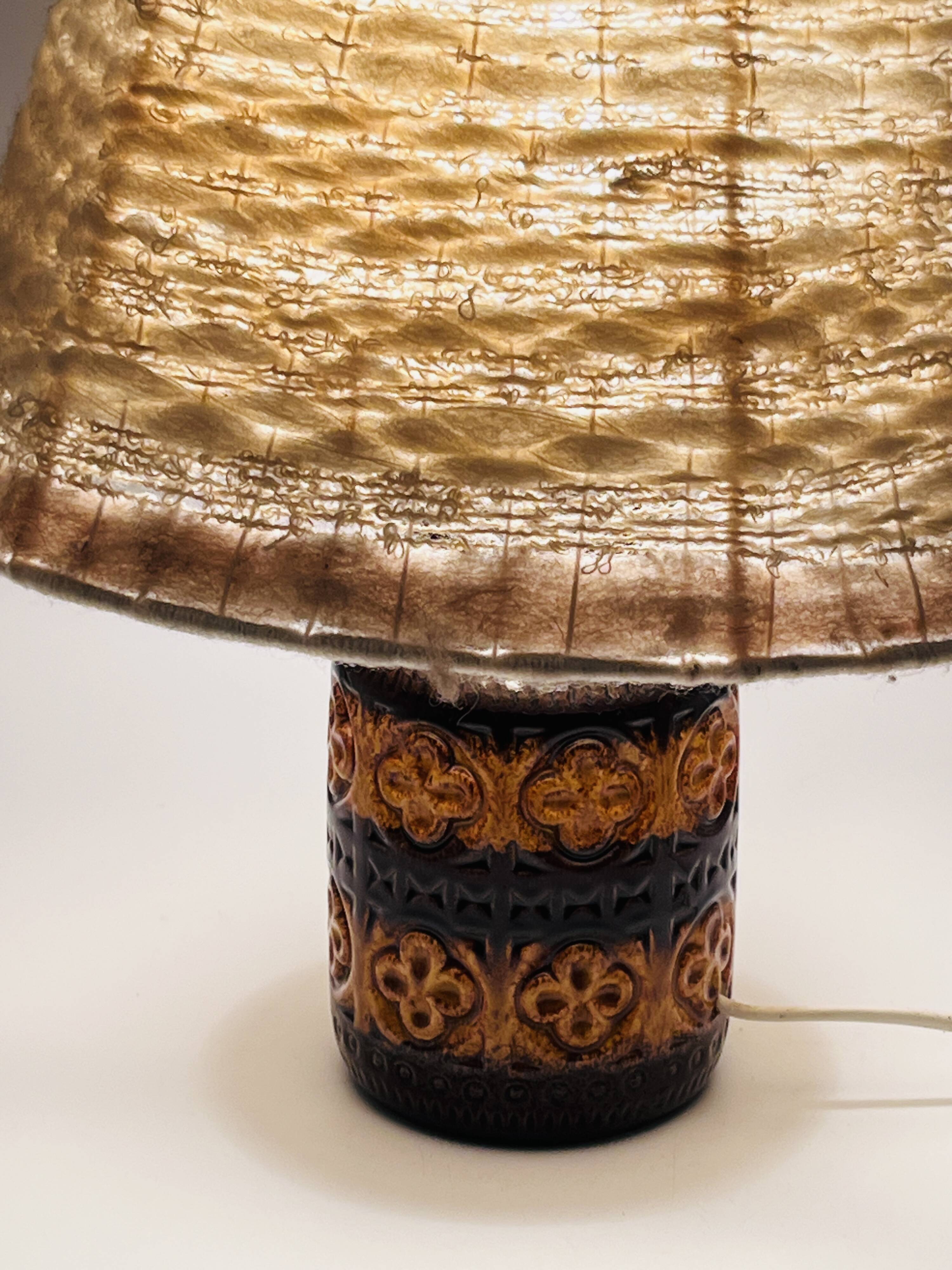 Vintage ceramic lamp with relief and wool shade.