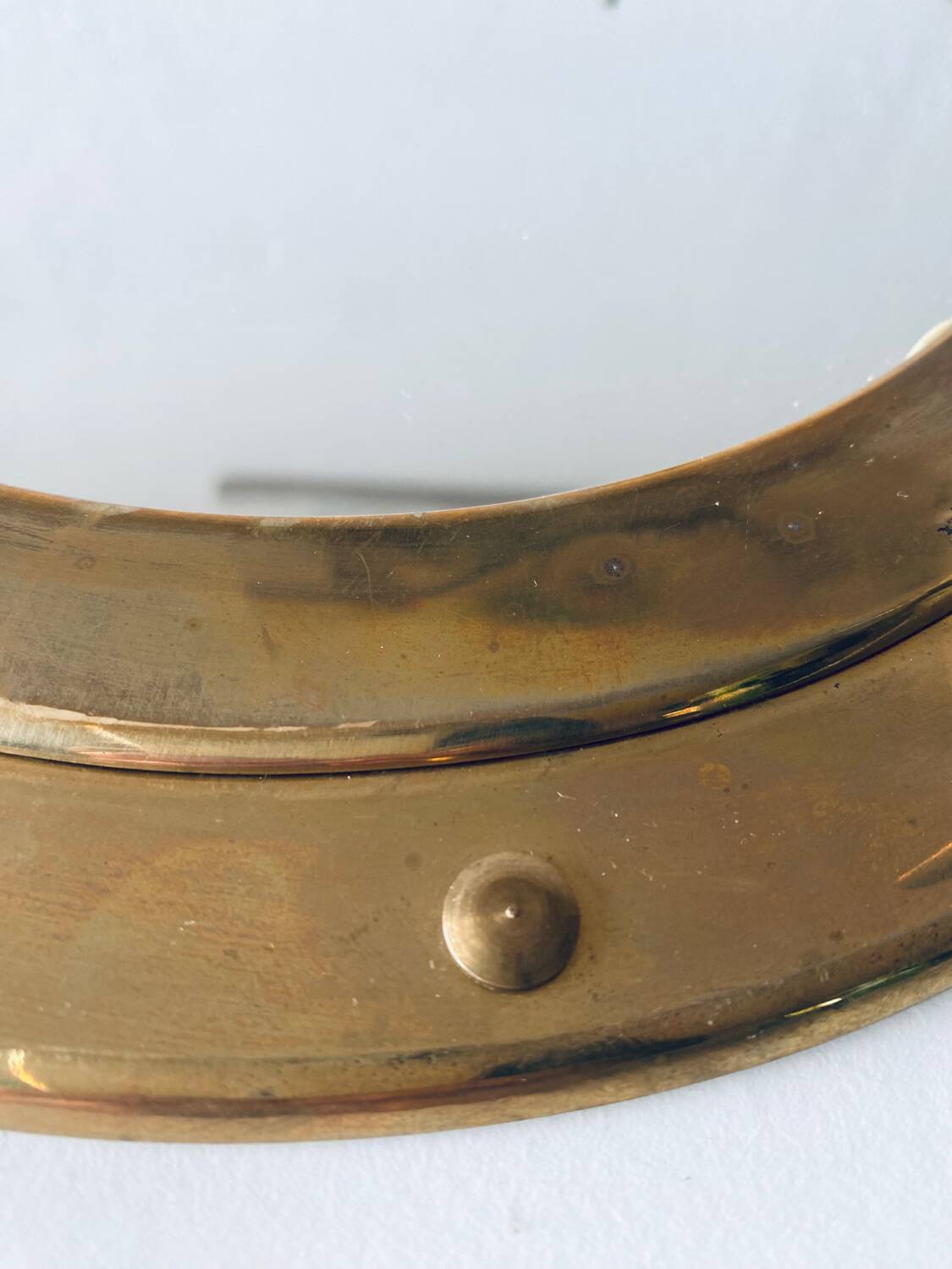 Porthole mirror in gilded brass