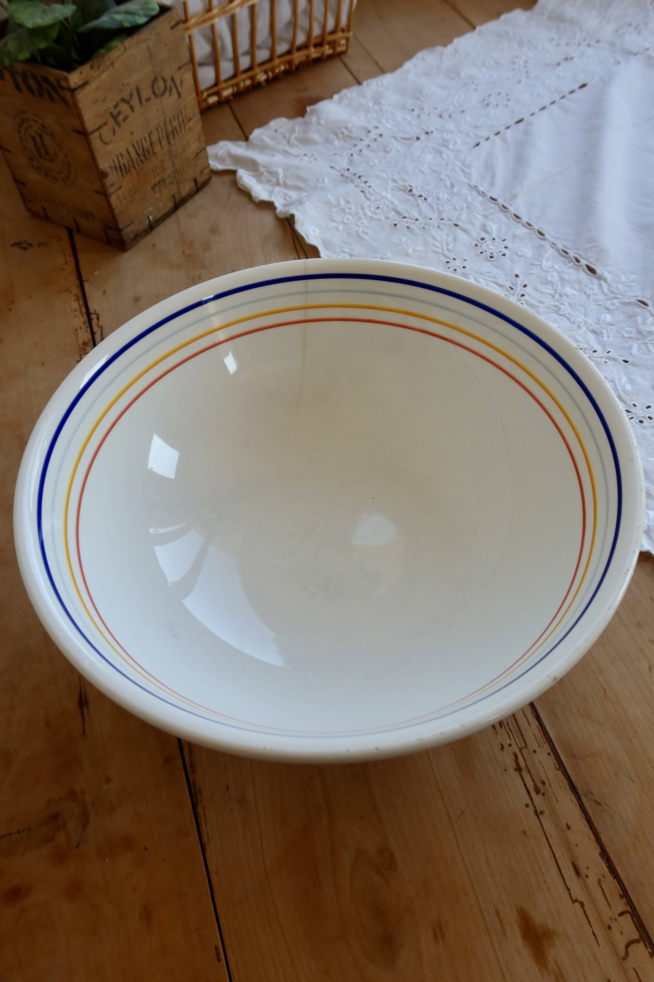 Vintage porcelain salad bowl with multicoloured borders.