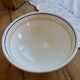 Vintage porcelain salad bowl with multicoloured borders.