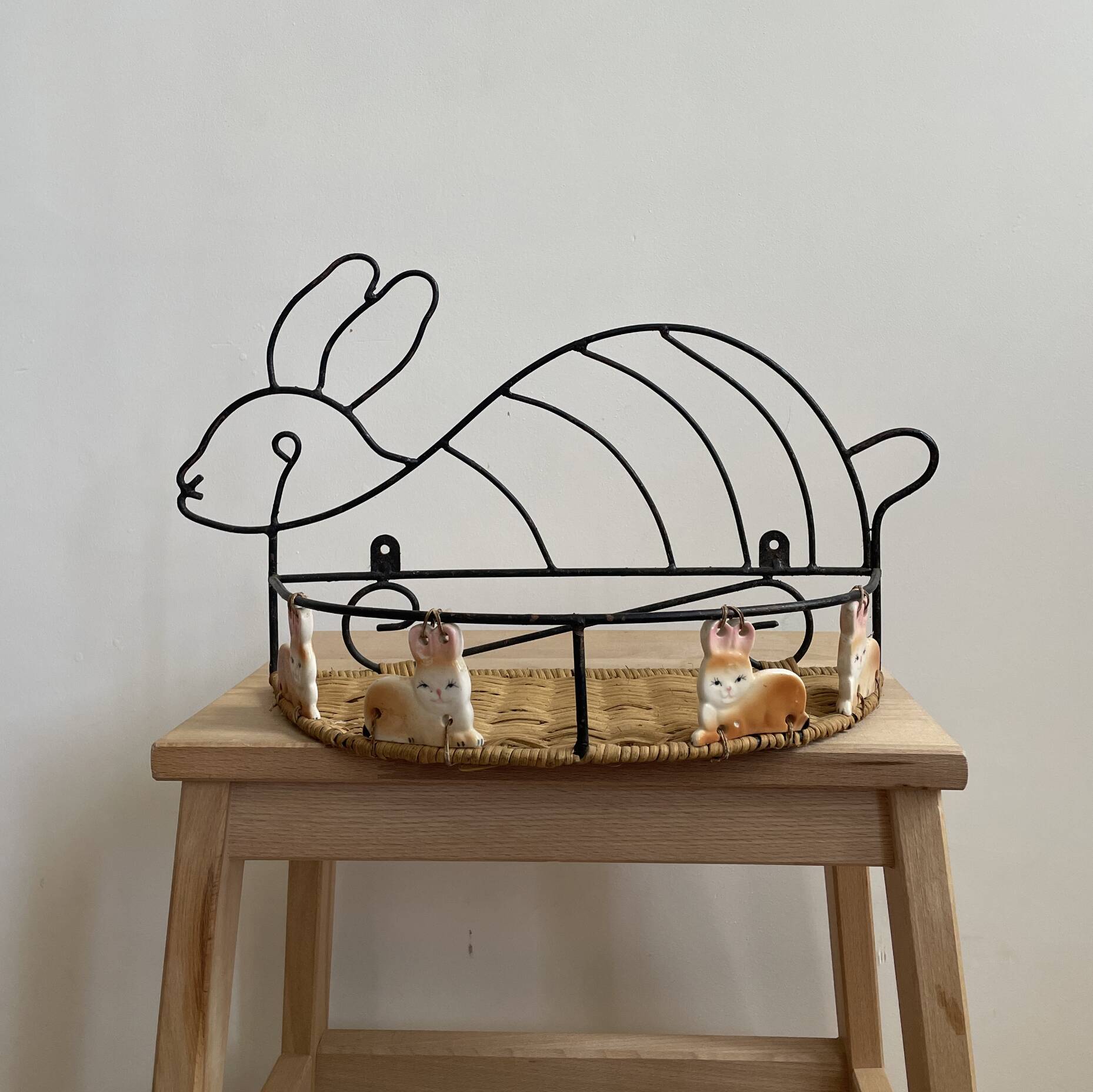 Wrought iron shelf and porcelain rabbit figurines