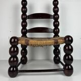 Brutalist wood turned bobbin low rush chair n the style of Charles Dudouyt