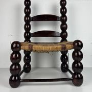 Brutalist wood turned bobbin low rush chair n the style of Charles Dudouyt