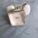 Antique earthenware salt cellar with a woman with baskets