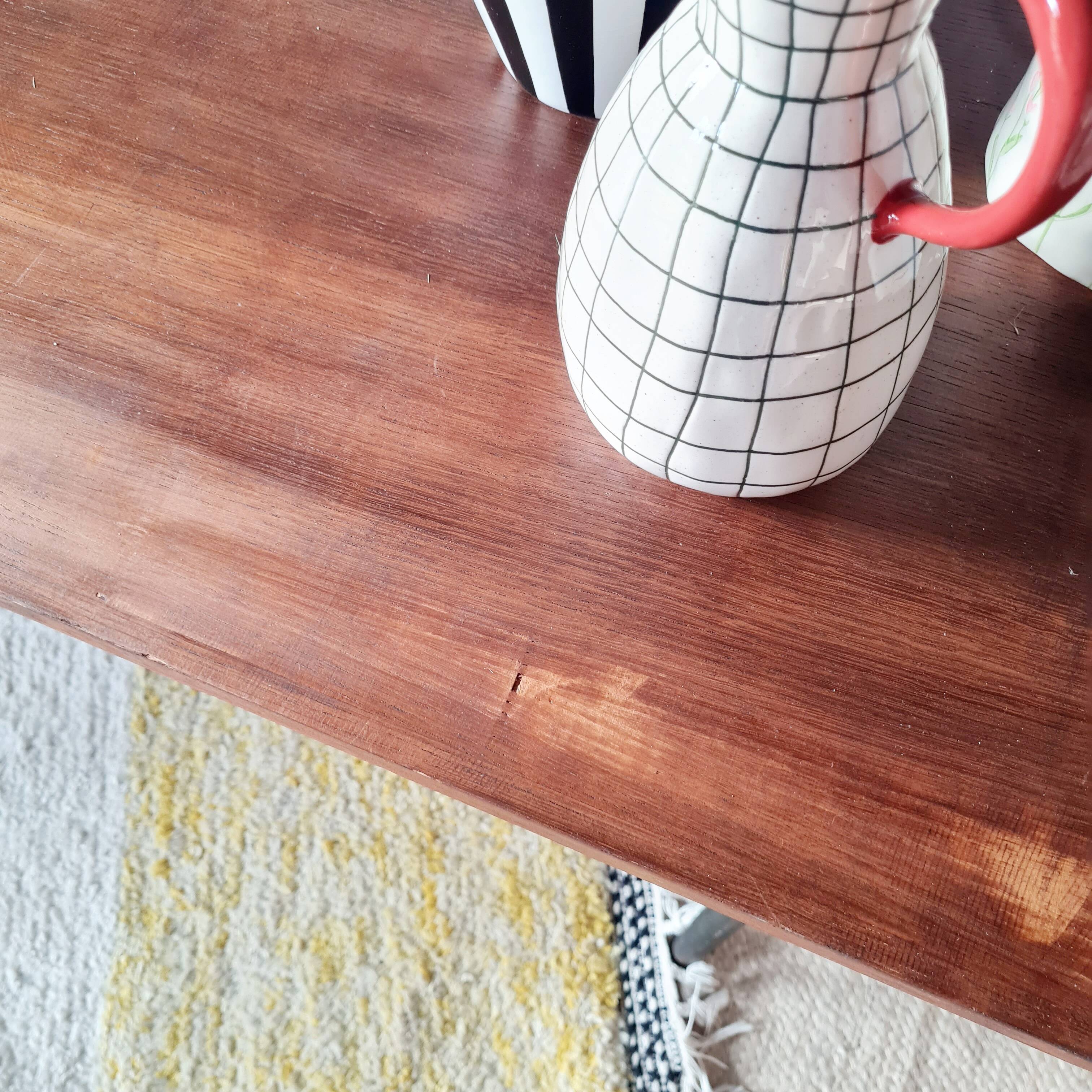 Metal tubular base table with a wooden top.