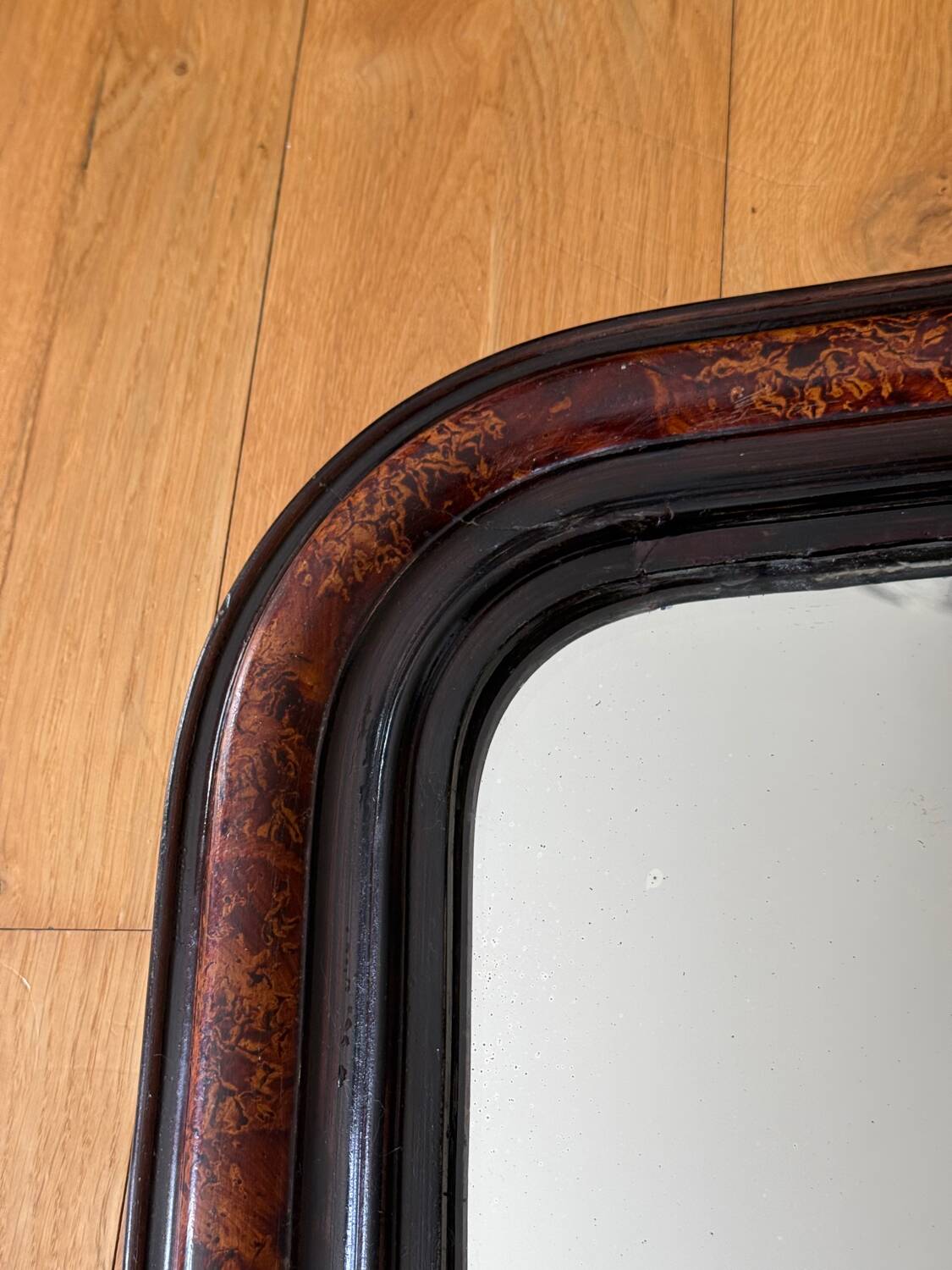 Antique Louis Philippe mirror in black and brown.