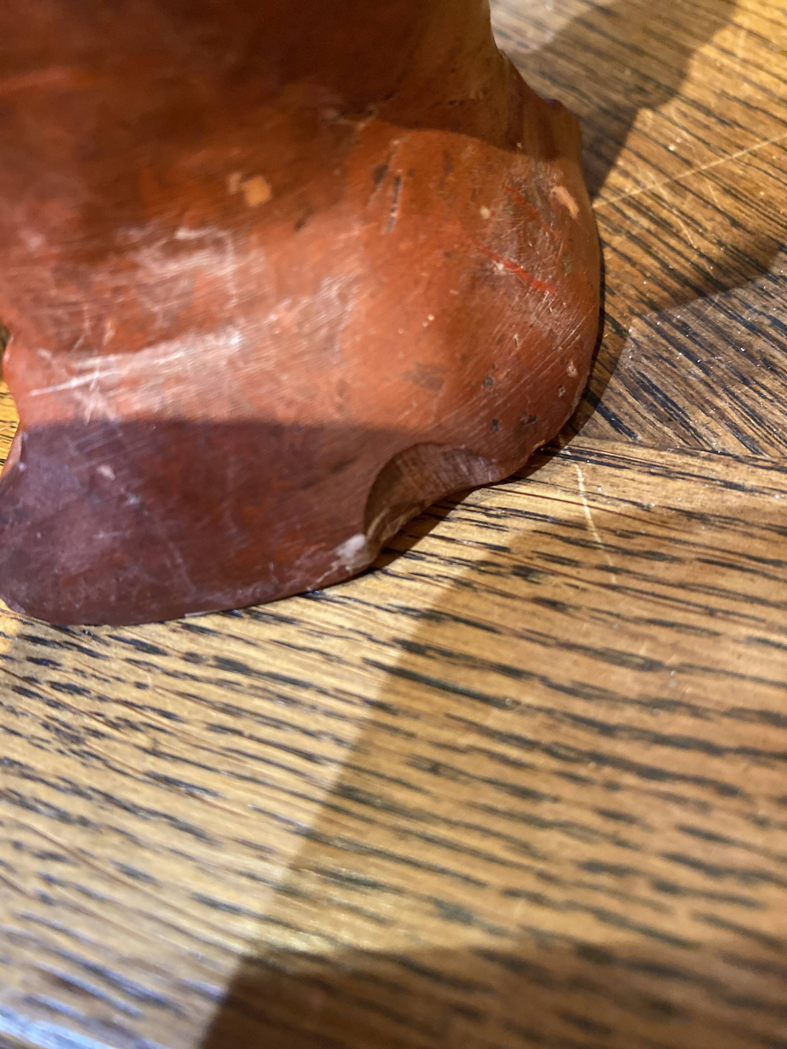 Soapstone sculpture on obsidian base of a Buddhist.