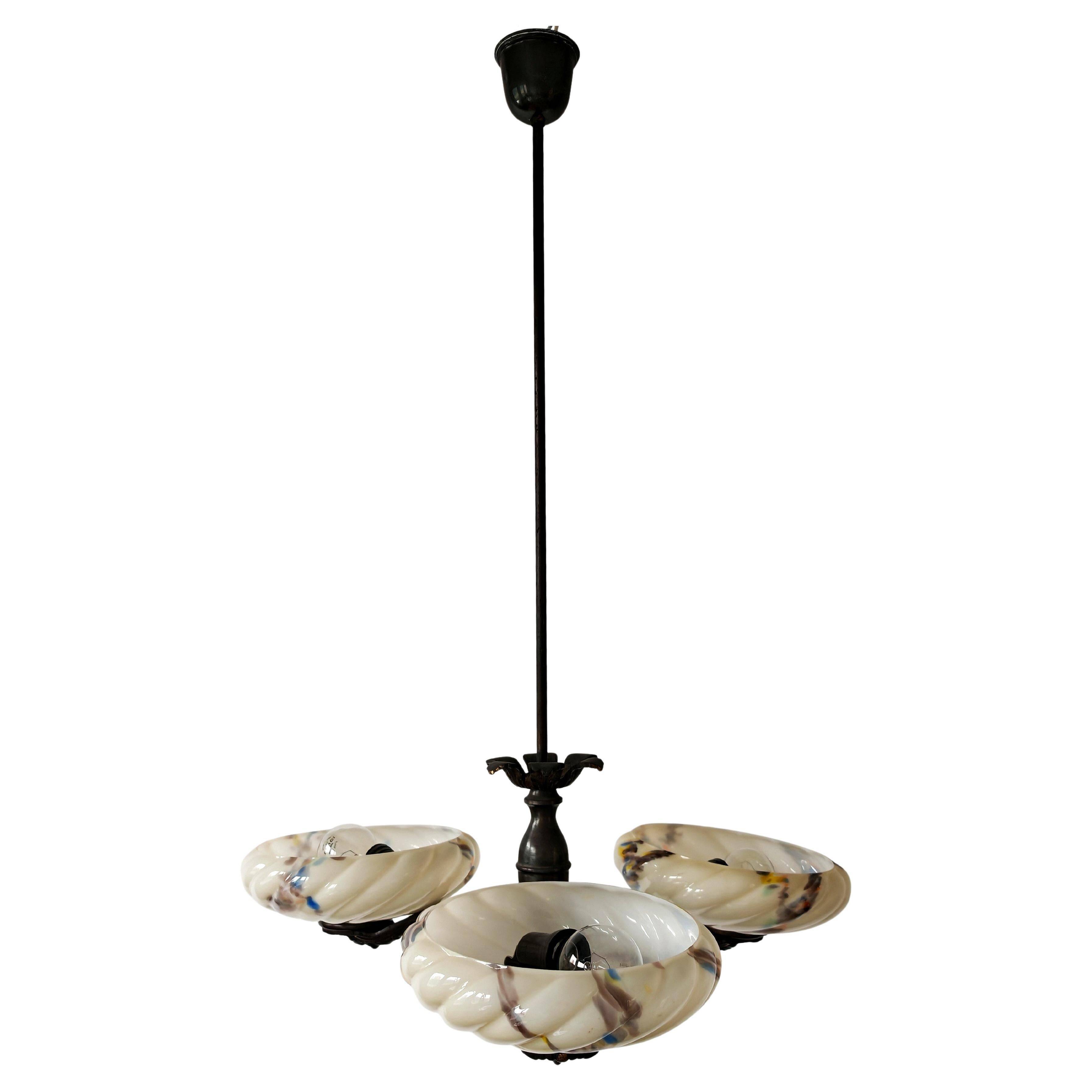 Art Deco bronze three-arm chandelier with marbled glass shades.
