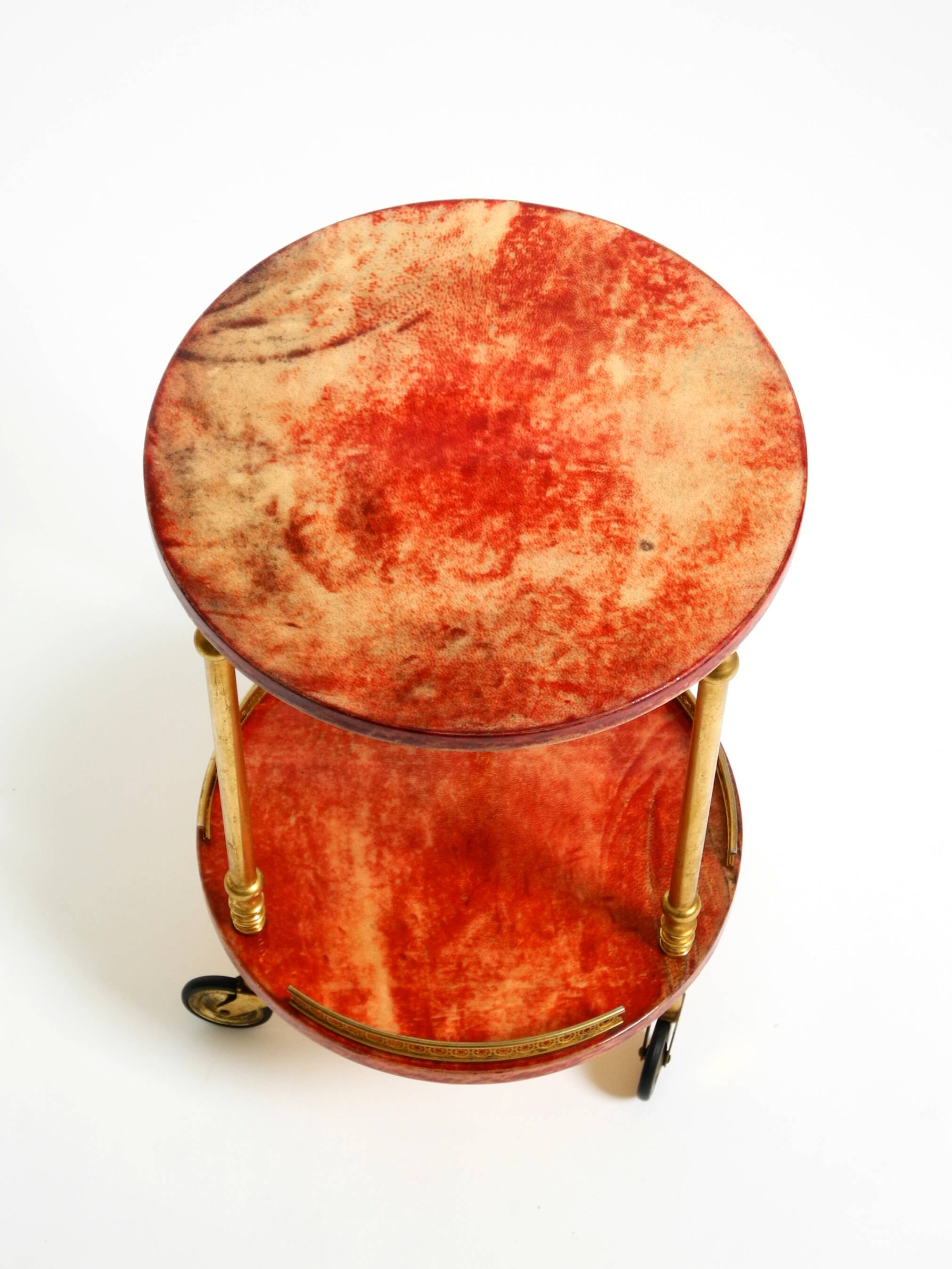 Round, small 1960s Aldo Tura serving or bar trolley in red goatskin leather