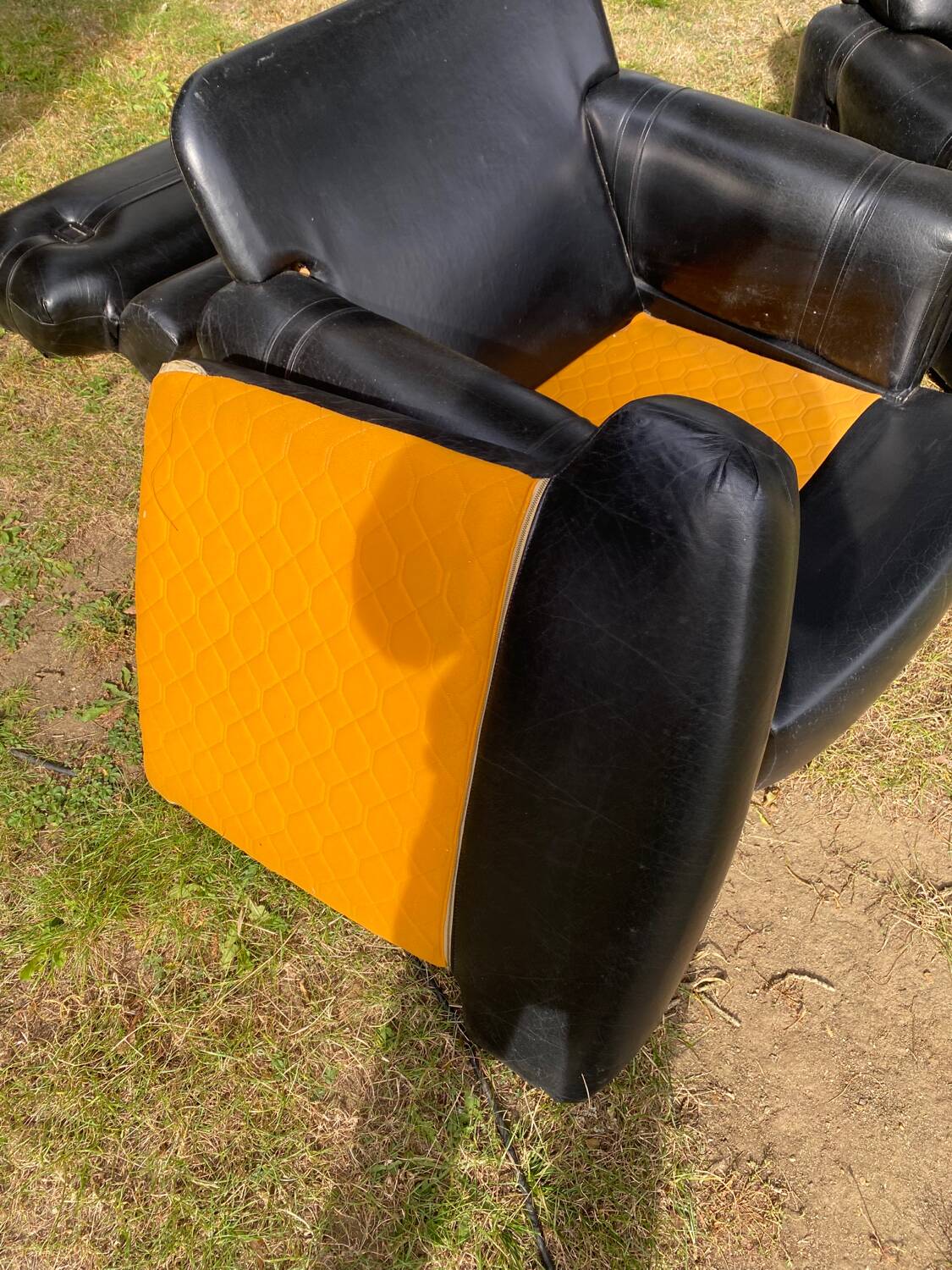 Pair of black imitation leather armchairs