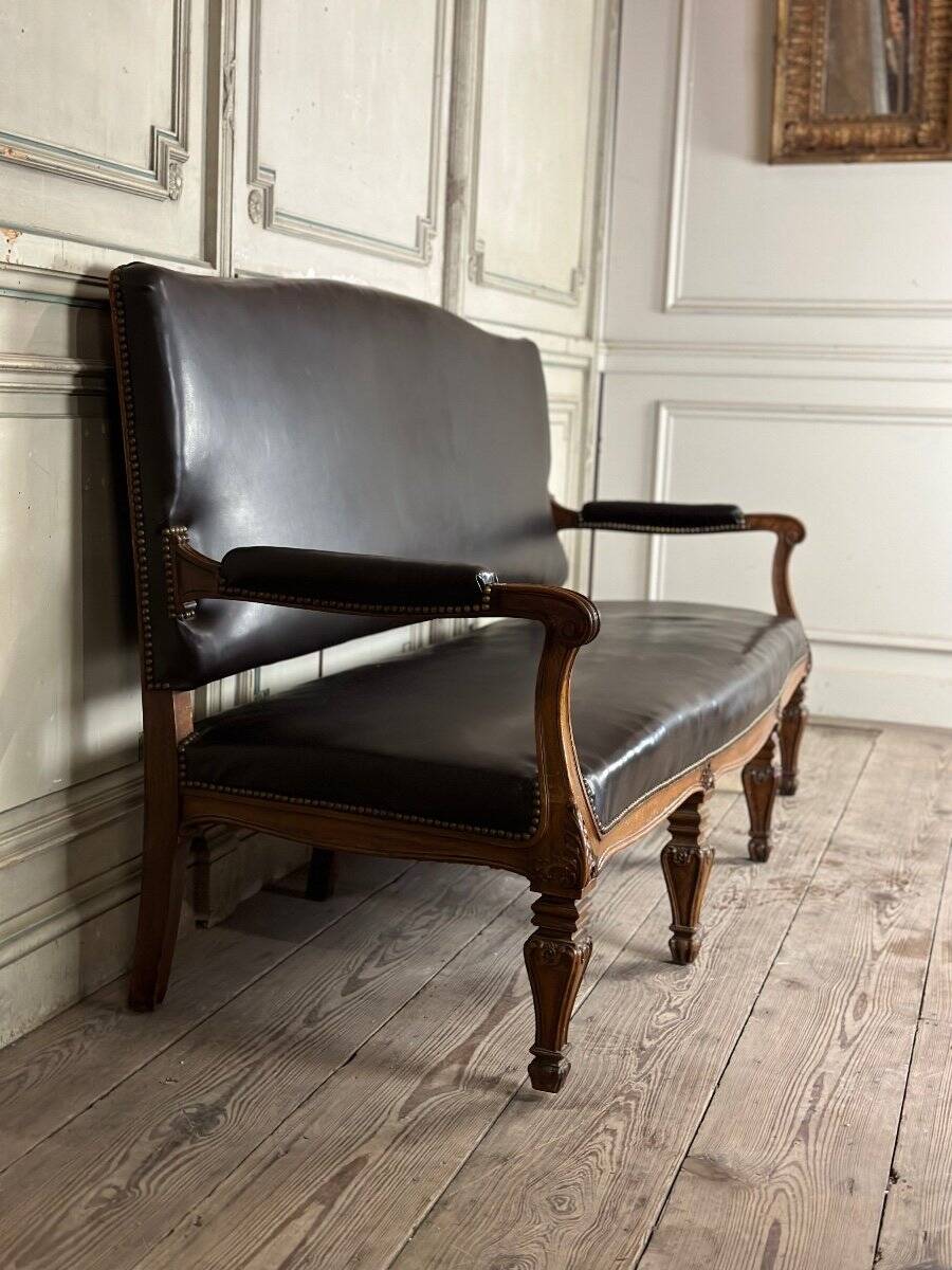 Napoleon III style bench in carved walnut, synthetic leather circa 1880