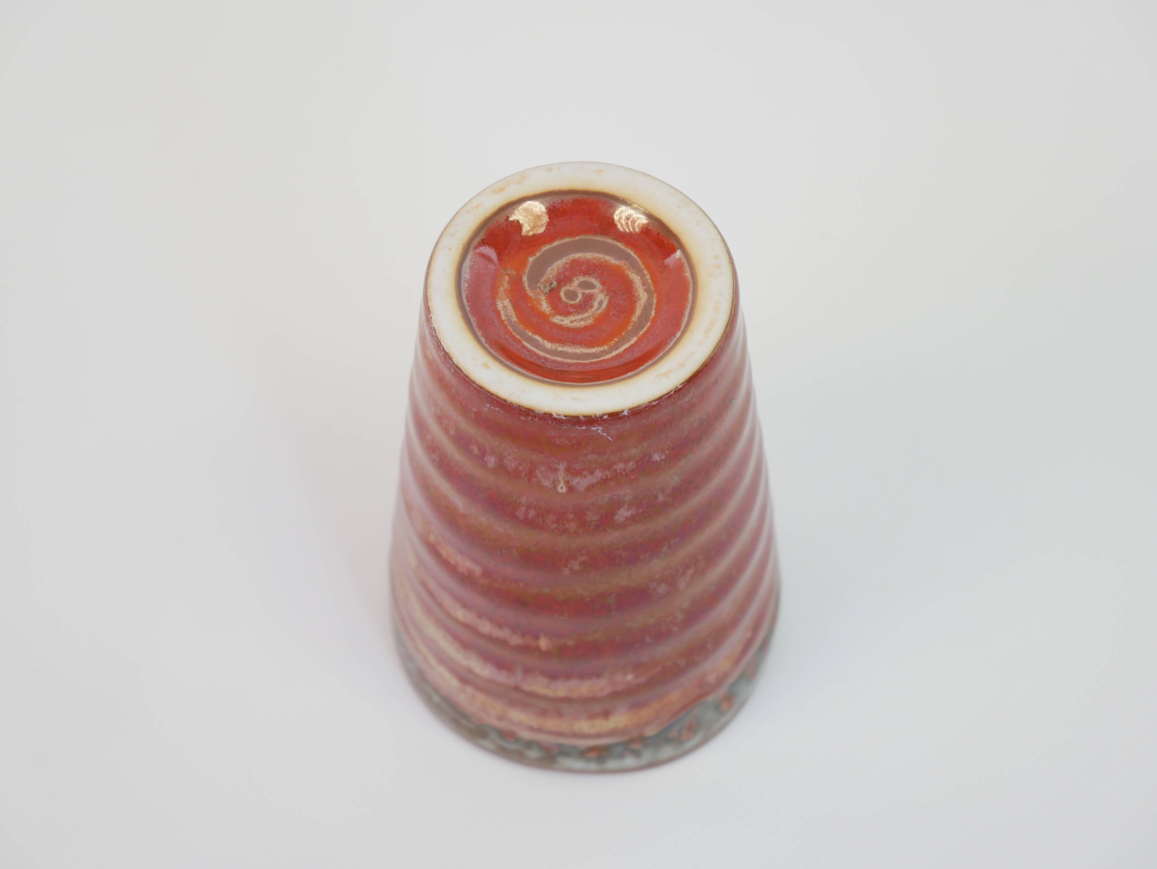 Small orange glazed ceramic cup