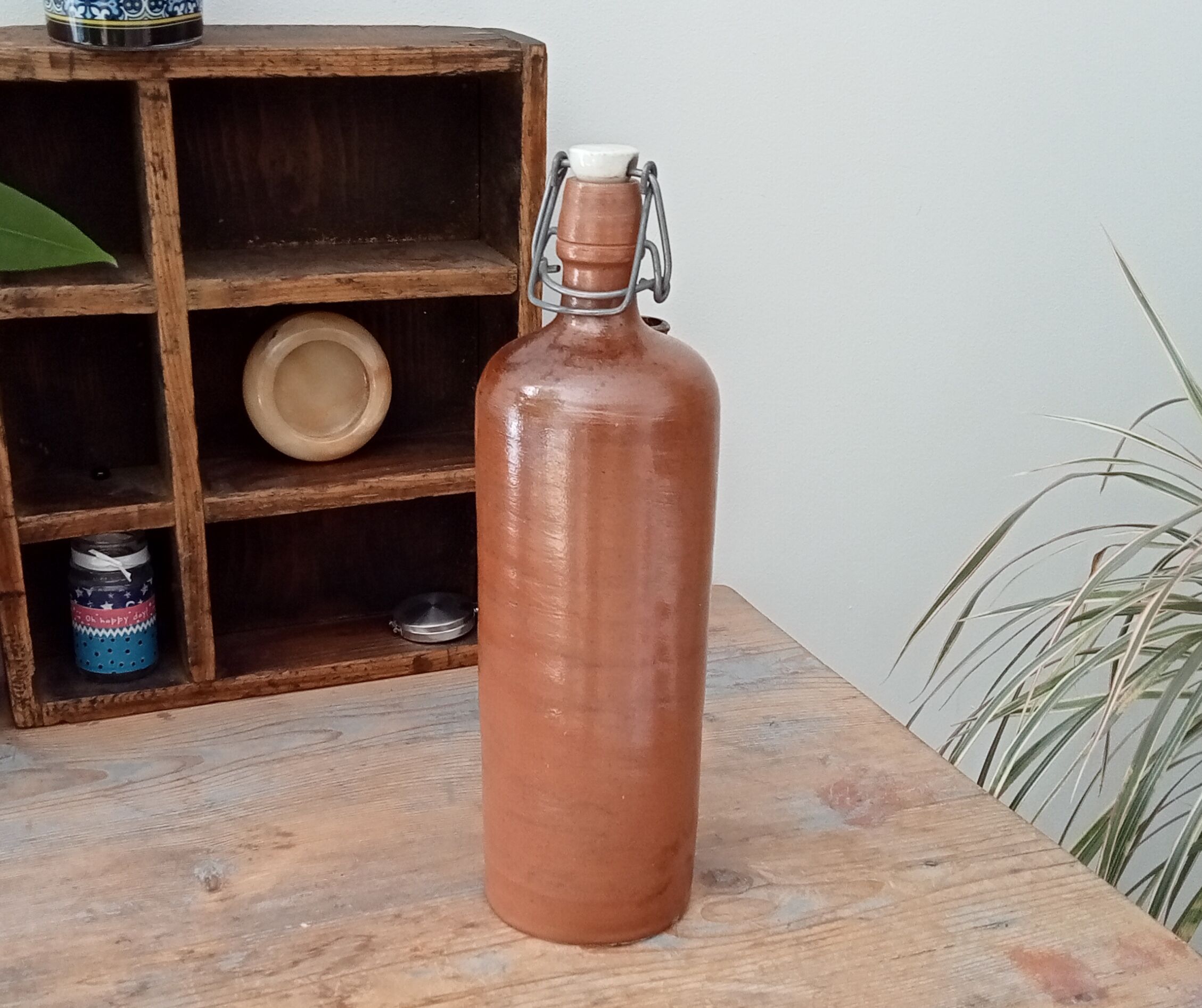 Old bottle in glazed sandstone