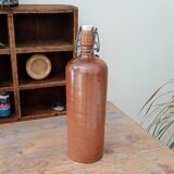 Old bottle in glazed sandstone