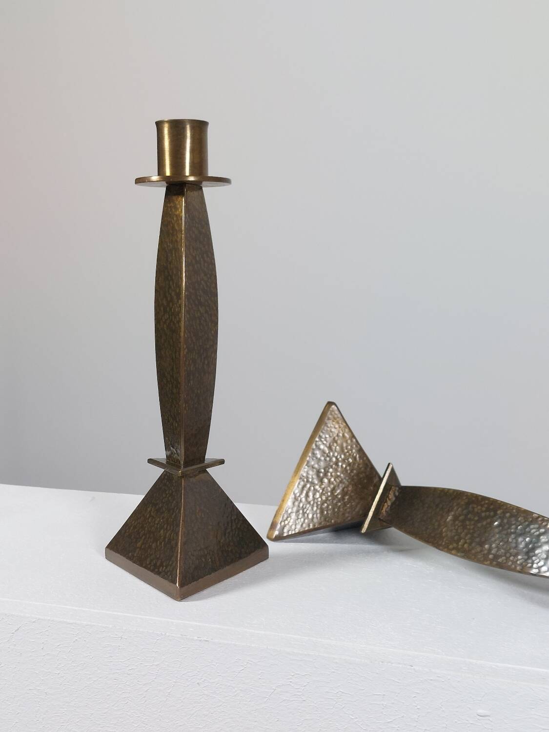 Pair of hand-hammered brass candlesticks in Memphis style.