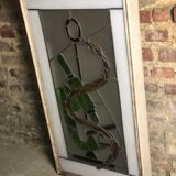 Old stained glass sign with deciduous decoration and microscope